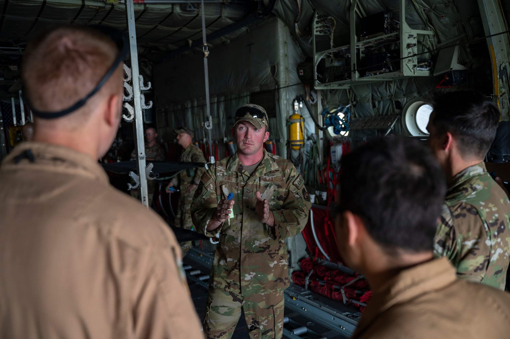 U.S. Air Force Staff Sgt. Brandon King, a loadmaster assigned to the 779th Expeditionary Airlift Squadron, interacts with visitors during a C-130H Hercules tour at Ali Al Salem Air Base, Kuwait, Oct. 9, 2021.