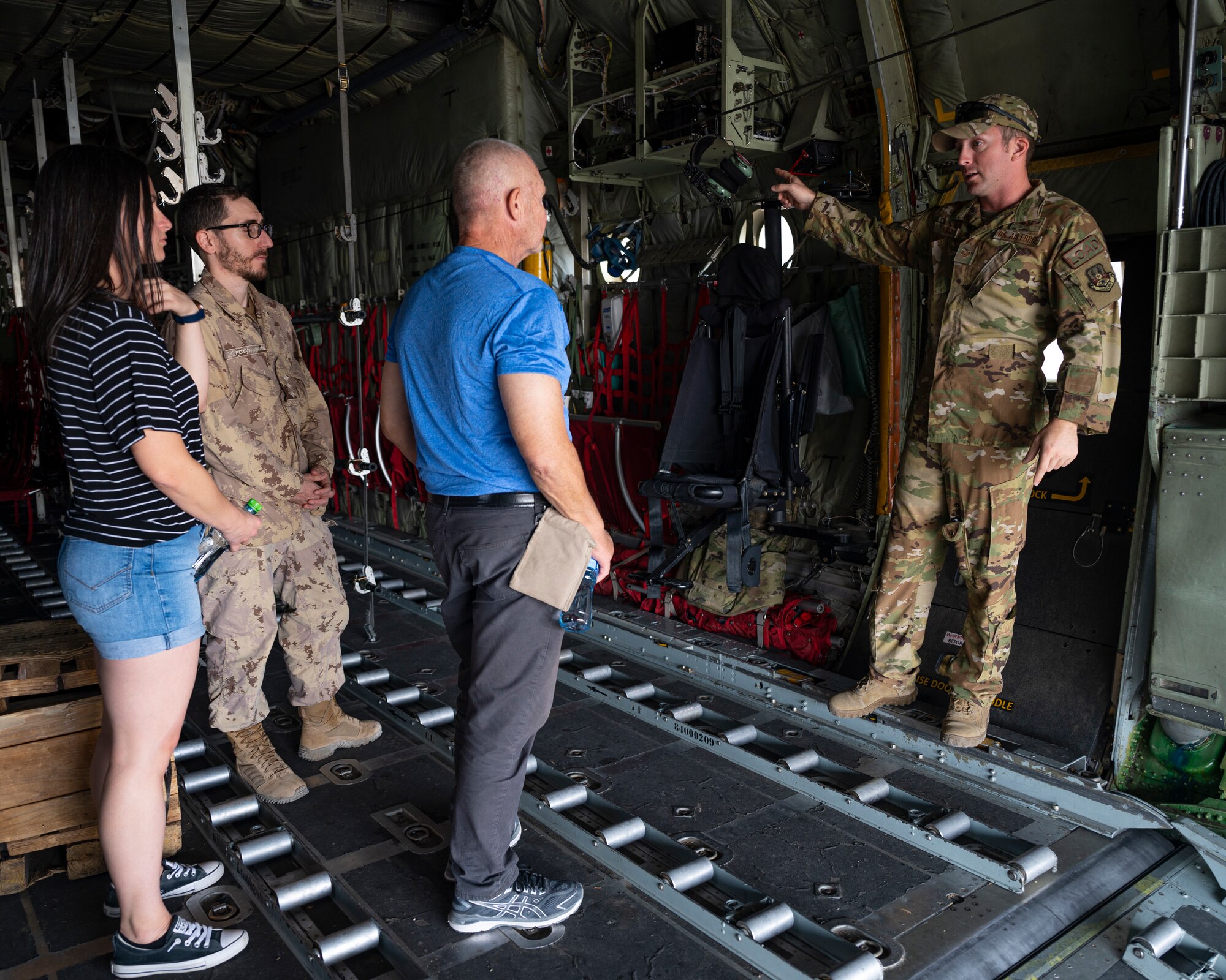 U.S. Air Force Staff Sgt. Brandon King, a loadmaster assigned to the 779th Expeditionary Airlift Squadron, interacts with visitors during a C-130H Hercules tour at Ali Al Salem Air Base, Kuwait, Oct. 9, 2021.