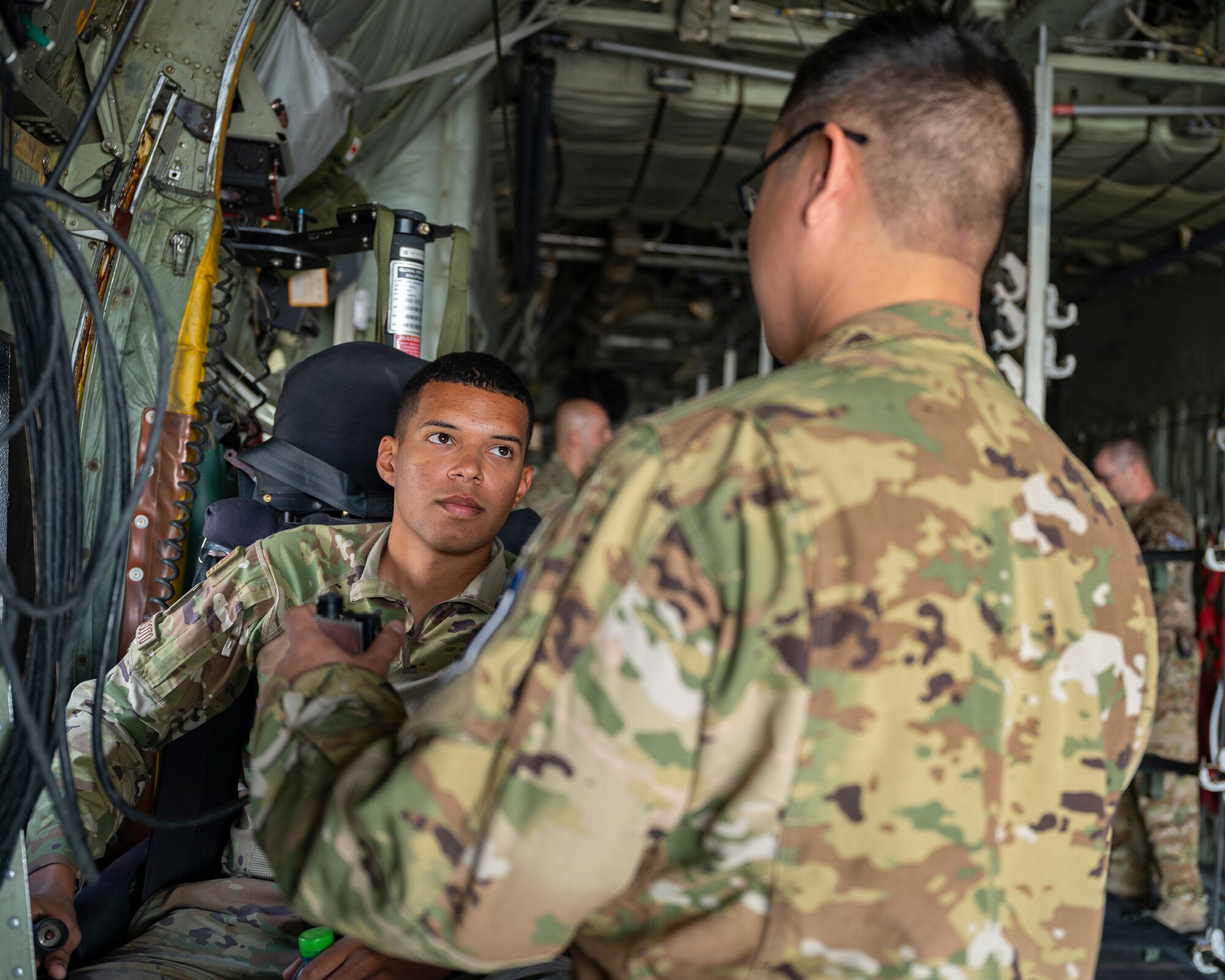 Tech. Sgt. Kyle Nagamatsu, a loadmaster assigned to the 779th Expeditionary Airlift Squadron, interacts with a visitor during a C-130H Hercules tour at Ali Al Salem Air Base, Kuwait, Oct. 9, 2021.