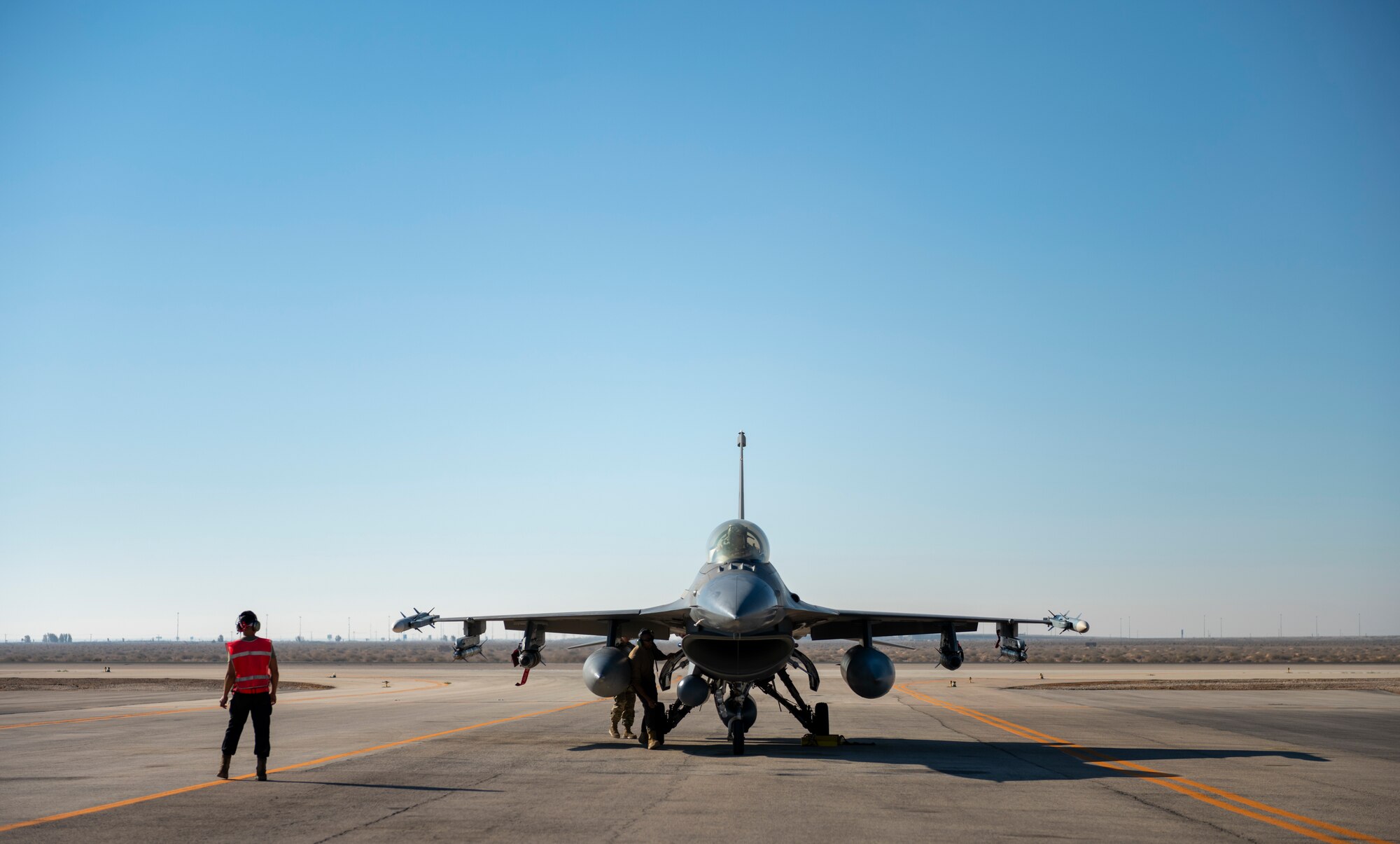 U.S. Airmen from the 332nd and 378th Air Expeditionary Wings conduct hot pit refueling of two U.S. F-16 Fighting Falcons Sept. 30, 2021, at an undisclosed location in Southwest Asia. The F-16s were forward-deployed from the 378th AEW, Prince Sultan Air Base, Kingdom of Saudi Arabia. Maintenance crews assigned to the 332nd and 378th AEWs conducted a hot-pit refueling training exchange over the course of several weeks, increasing their agile combat employment capabilities by ensuring both F-16 Fighting Falcons and F-15E Strike Eagles can be refueled by each wing. (U.S. Air Force photo by Master Sgt. Traci Keller)