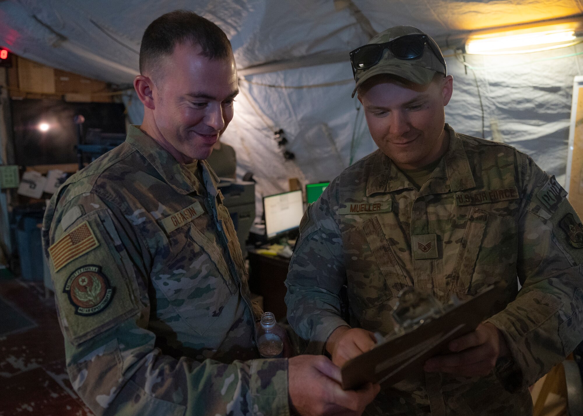 U.S. Air Force Staff Sgts. Grant Gleason and Jacob Mueller, 443rd Air Expeditionary Squadron heavy equipment operators, review documents at Al Asad Air Base, Iraq, Sept. 22, 2021.