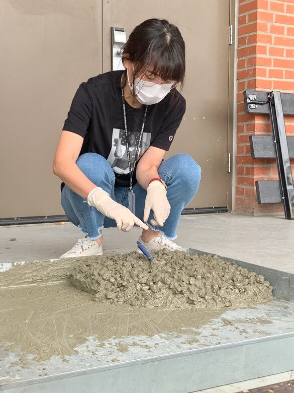 Min Chae Kim, an FED Geotechnical Materials Lab civil engineer, conducts a temperature check on a mix of concrete as part of testing for the American Concrete Institute certification, held at the Far East District Materials Testing Lab, Sept. 30.