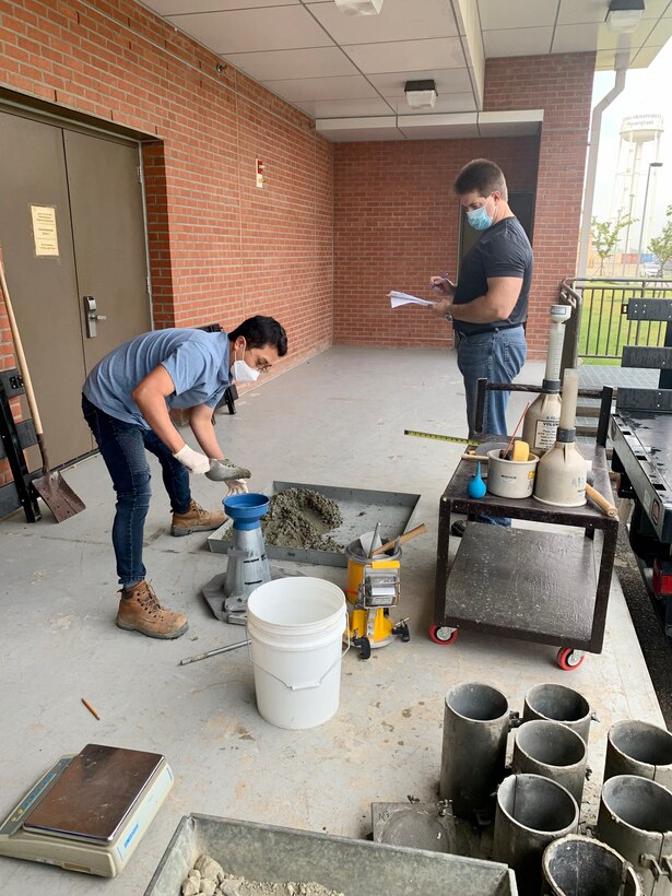 Jae Ung Yoon (left), an FED Geotechnical Materials Lab civil engineer, performs the slump test, evaluated by Chad Gartrell (right), American Concrete Institute instructor, during the ACI workshop, held at the Far East District Materials Testing Lab, Sept. 30.