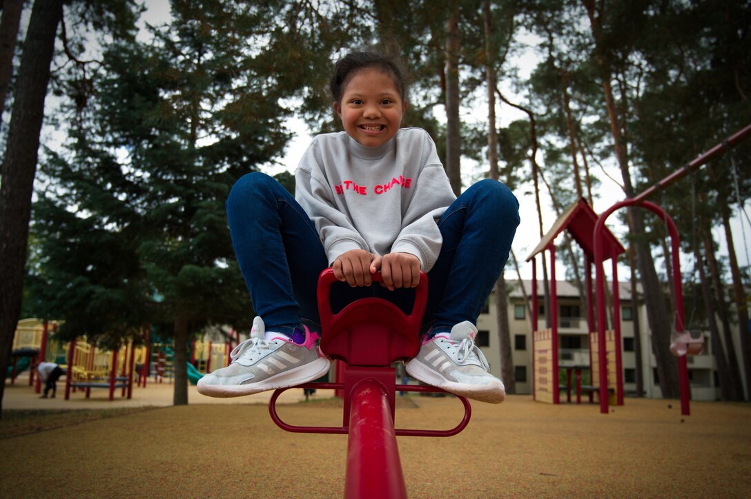Maya Lute, daughter of U.S. Air Force Staff Sgt. Karmalita Phipps, 86th Dental Squadron dental technician, plays on a teeter-totter at Ramstein Air Base, Oct. 5, 2021. October is Down syndrome awareness month and Lute is one of the few kids in the Kaiserslautern Military Community with Down syndrome. As with many genetic and developmental disorders, Down syndrome operates on a spectrum of presentation and can look completely different for each individual child. (U.S. Air Force photo by Senior Airman Branden Rae)