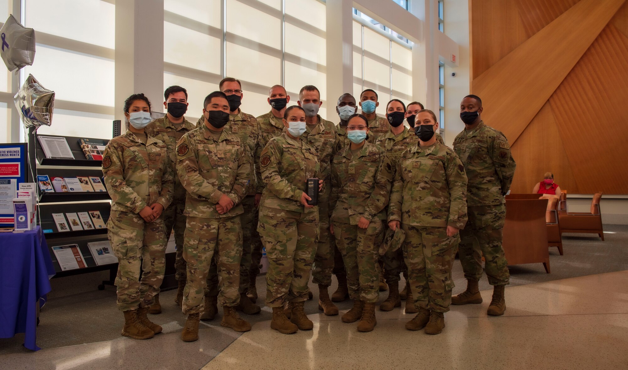 An Airman is photographed with their superiors and team