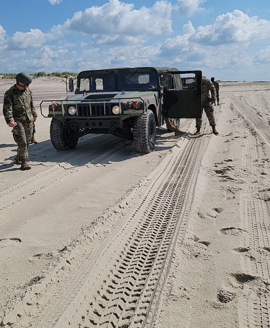 Humvees negotiate the driving course at Smith Point County Park near Mastic Beach, New York, on July 9, 2021, during driver training conducted by the 106th Rescue Wing of the New York Air National Guard. The 106th Rescue Wing fields an immediate response force of five high-axle military vehicles and 20 personnel when natural disasters and emergencies hit Long Island.