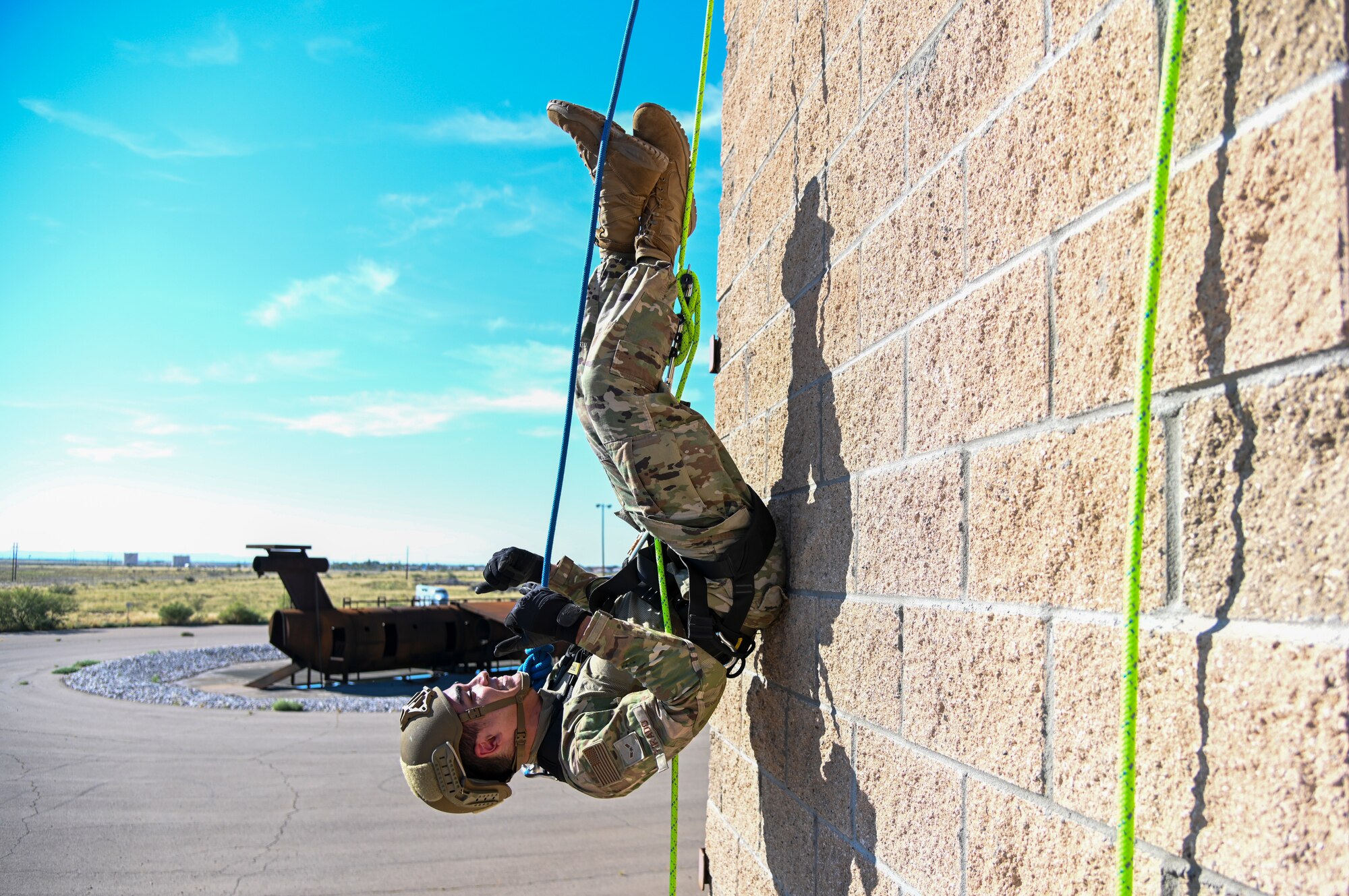 Airman 1st Class Isaiah Tirado, 49th Security Forces Squadron installation entry controller, hangs upside down during the 49th Wing’s first rappel skills training, Oct. 5, 2021, on Holloman Air Force Base, New Mexico. Holloman Defenders and firefighters learned rappel skills to use for rapid building entry and exit in hostile situations. (U.S. Air Force photo by Airman 1st Class Jessica Sanchez-Chen)