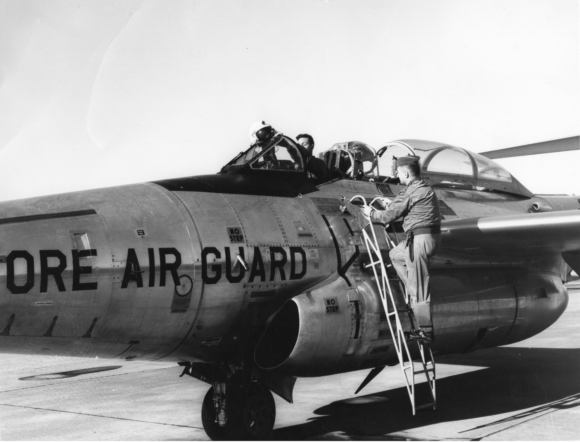 Oregon Air National Guard 123rd Fighter-Interceptor Squadron F-89J Scorpion pilot Bradford A. Newell sits in the front cockpit with hands by his helmet in this undated picture from the early 1960’s, as another crewmember, probably the aircraft’s radar observer, stands on the ladder.  Perhaps they have just finished a sortie in this natural-metal finish Northrop F-89J Scorpion fighter-interceptor.  (142nd Wing History Archive)