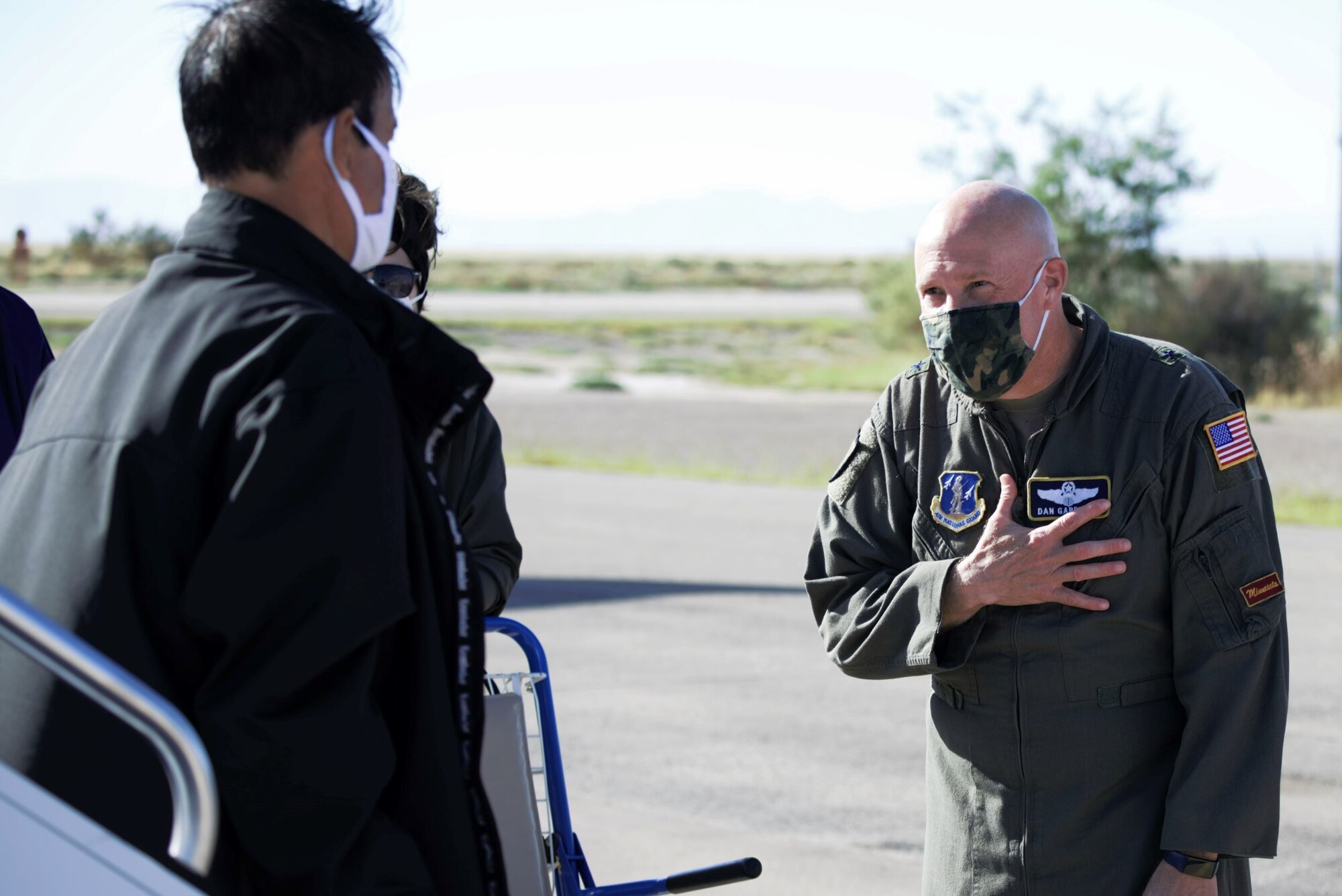 Brig. Gen. Daniel Gabrielli, right, Task Force Holloman commander, welcomes an Afghan evacuee arriving to TF Holloman with a traditional Afghan gesture at Holloman Air Force Base, New Mexico, Oct. 10, 2021. The Department of Defense, through U.S. Northern Command, and in support of the Department of State and Department of Homeland Security, is providing transportation, temporary housing, medical screening, and general support for at least 50,000 Afghan evacuees at suitable facilities, in permanent or temporary structures, as quickly as possible. This initiative provides Afghan evacuees essential support at secure locations outside Afghanistan. (U.S. Navy photo by Mass Communications Specialist 1st Class Sarah Rolin)