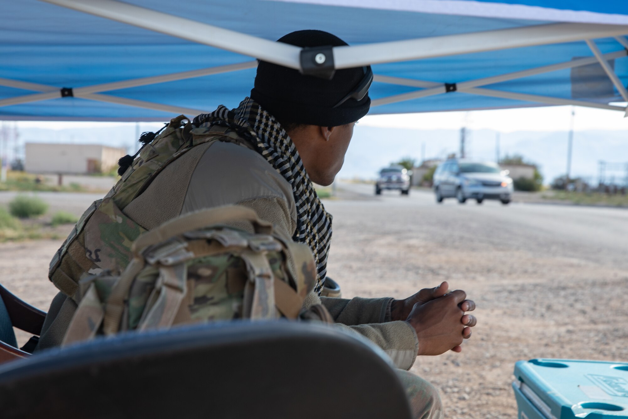 An Airman deployed with the 822nd Base Defense Squadron from Moody Air Force Base, Georgia, provides force protection to Aman Omid Village on Holloman Air Force Base, New Mexico, Oct. 7, 2021. The Department of Defense, through the U.S. Northern Command, and in support of the Department of State and Department of Homeland Security, is providing transportation, temporary housing, medical screening, and general support for at least 50,000 Afghan evacuees at suitable facilities, in permanent or temporary structures, as quickly as possible. This initiative provides Afghan evacuees essential support at secure locations outside Afghanistan. (U.S. Army photo by Spc. Nicholas Goodman)