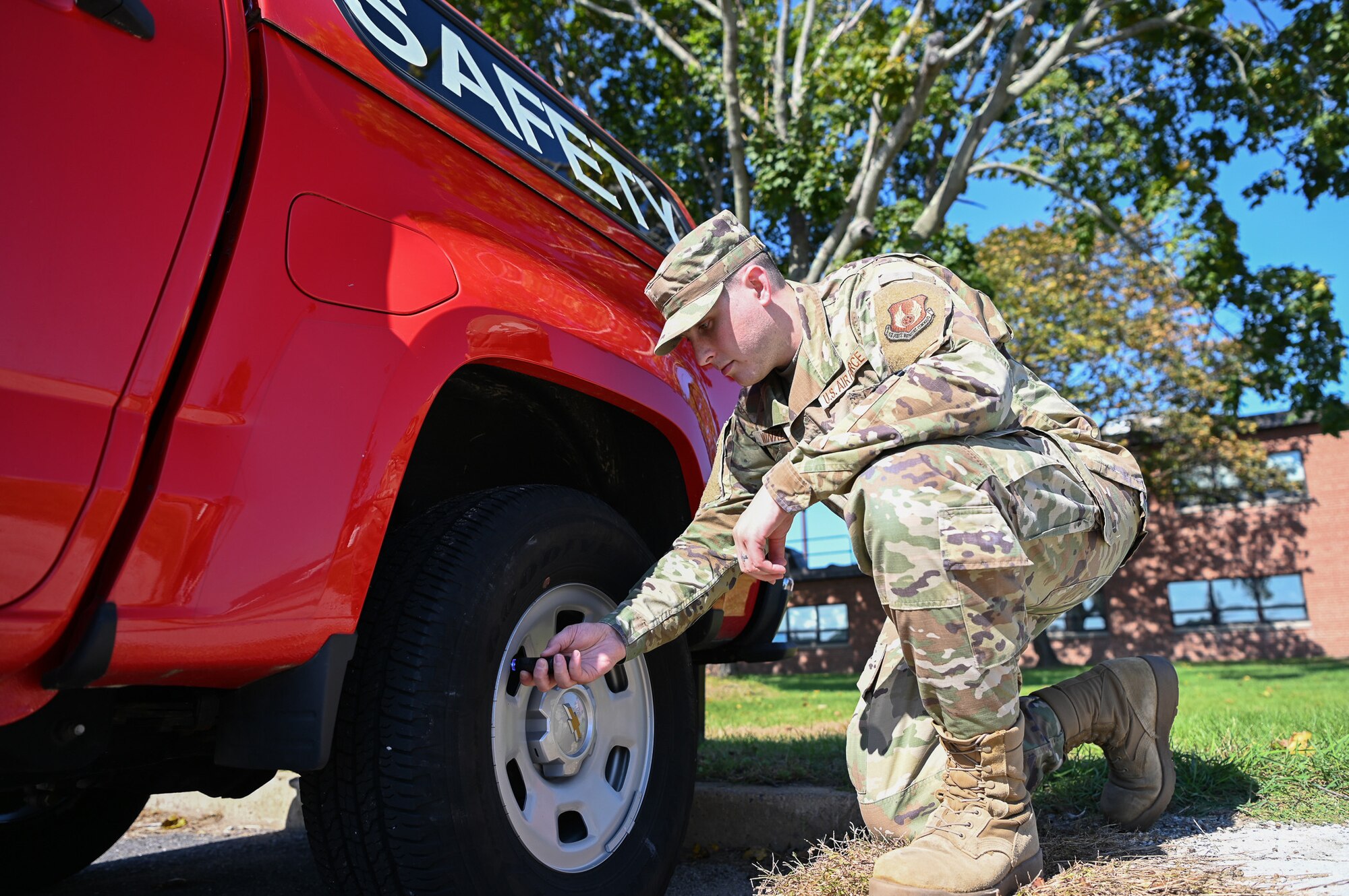 Airman checks tire pressure