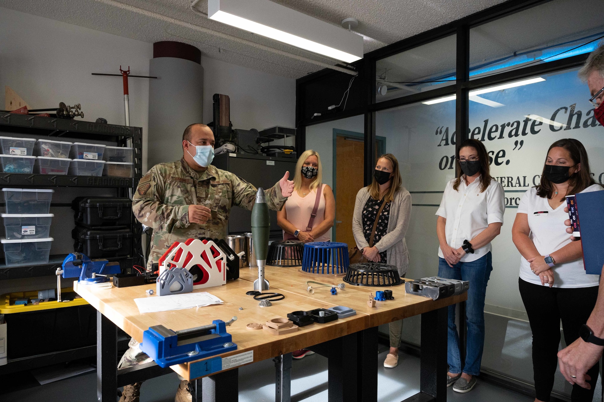 Master Sgt. Brandon Vazquez, Bedrock Innovation Lab chief of technology, showcases 3D printer products during a key spouse immersion tour at Dover Air Force Base, Delaware, Oct. 13, 2021. The tour featured facilities around base such as the Bedrock Innovation Lab, military working dog kennels and Air Force Mortuary Affairs Operations. The immersion aimed to familiarize and better equip spouses in assisting Airmen and their families. (U.S. Air Force photo by Senior Airman Faith Schaefer)