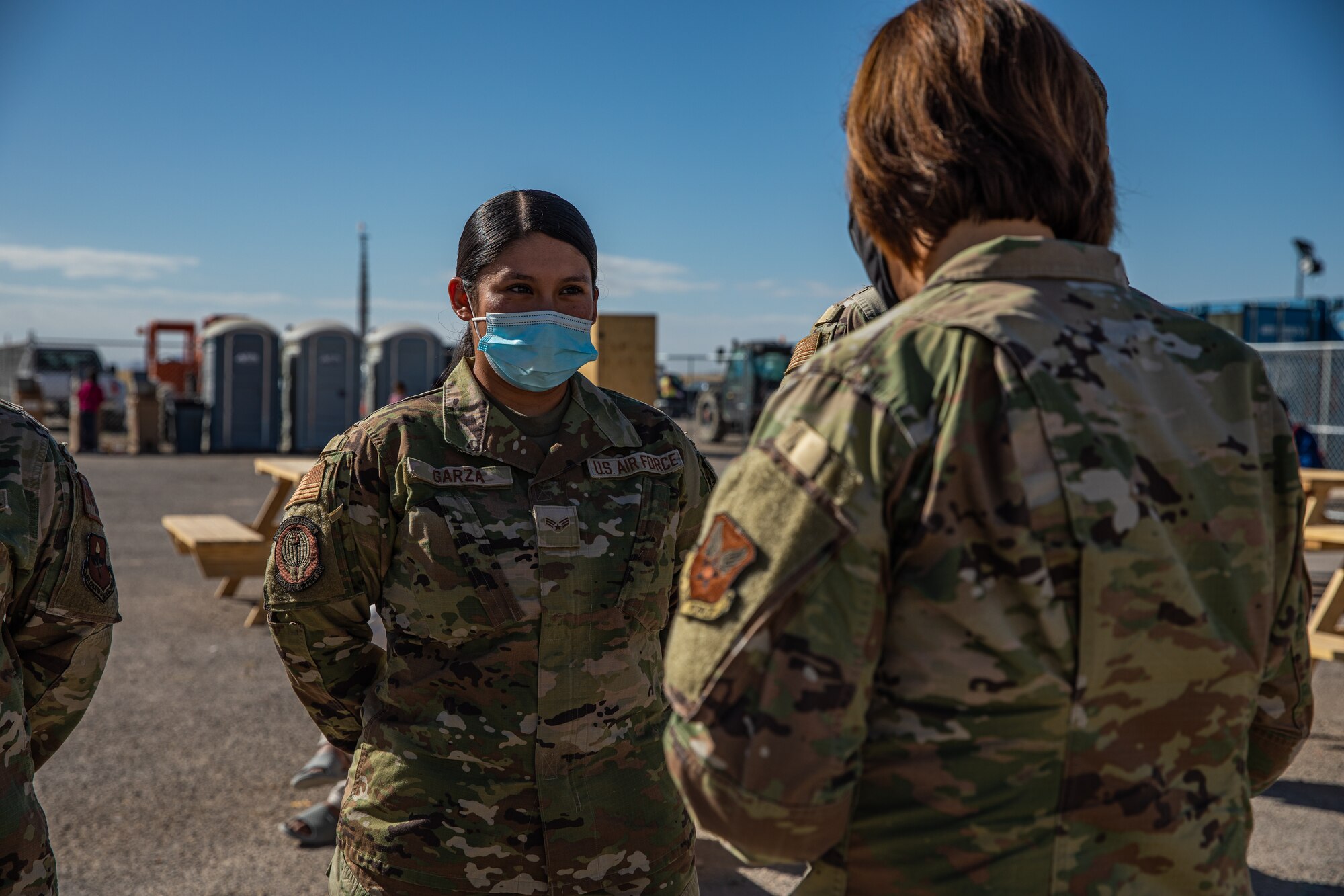 Chief Master Sgt. of the Air Force JoAnne S. Bass presents a coin to Senior Airman Leslie Garza, Task Force-Holloman personnel support for contingency operations deployed from Randolph Air Force Base, Texas, on Holloman AFB, New Mexico, Oct. 13, 2021. The Department of Defense, through U.S. Northern Command, and in support of the Department of Homeland Security, is providing transportation, temporary housing, medical screening, and general support for at least 50,000 Afghan evacuees at suitable facilities, in permanent or temporary structures, as quickly as possible. This initiative provides Afghan personnel essential support at secure locations outside Afghanistan. (U.S. Army photo by Pfc. Anthony Sanchez)