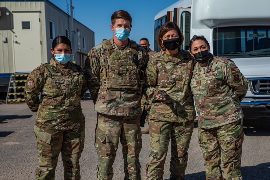 Chief Master Sgt. of the Air Force JoAnne S. Bass poses for a picture with the Task Force-Holloman Airmen who were presented coins during a visit to Holloman Air Force Base, New Mexico, Oct. 13, 2021. The Department of Defense, through U.S. Northern Command, and in support of the Department of Homeland Security, is providing transportation, temporary housing, medical screening, and general support for at least 50,000 Afghan evacuees at suitable facilities, in permanent or temporary structures, as quickly as possible. This initiative provides Afghan personnel essential support at secure locations outside Afghanistan. (U.S. Army photo by Pfc. Anthony Sanchez)