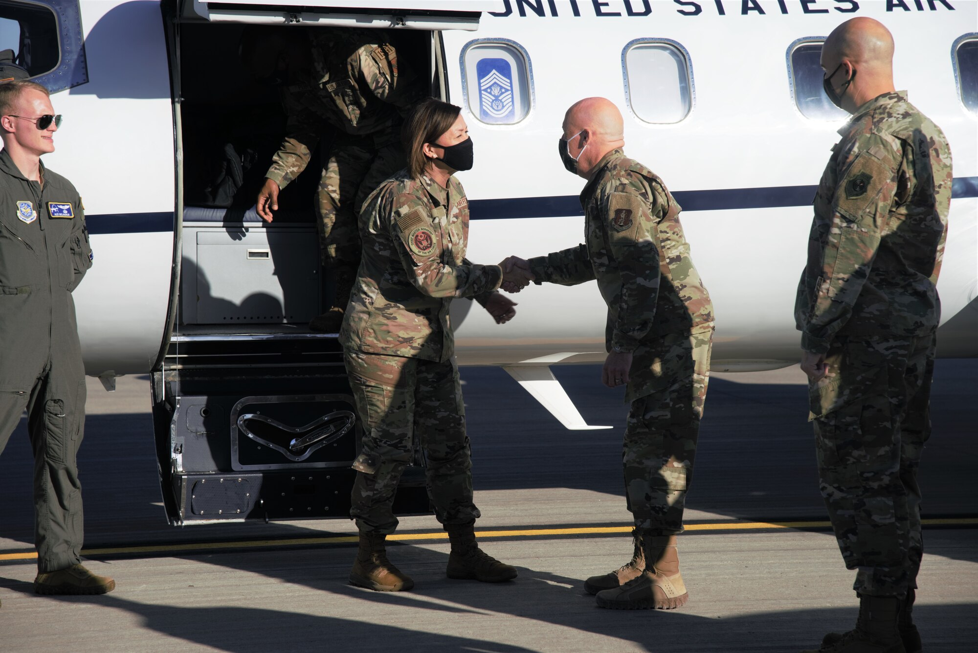Brig. Gen. Daniel Gabrielli, Task Force-Holloman commander, greets Chief Master Sgt. of the Air Force JoAnne S. Bass as she arrives to tour and meet Airmen and Guardians from the 49th Wing and Task Force-Holloman on Holloman Air Force Base, New Mexico, Oct. 13, 2021. The Department of Defense, through U.S. Northern Command, and in support of the Department of State and Department of Homeland Security, is providing transportation, temporary housing, medical screening, and general support for at least 50,000 Afghan evacuees at suitable facilities, in permanent or temporary structures, as quickly as possible. This initiative provides Afghan evacuees essential support at secure locations outside Afghanistan. (U.S. Navy photo by Mass Communications Specialist 1st Class Sarah Rolin)
