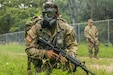 U.S. Army Spc. Justin Earnhart, 470th Military Intelligence Brigade, pulls security while wearing a joint service general purpose mask during an exercise in the Army Futures Command Best Warrior Competition on Fort Sam Houston, Texas, June 9 2021. The Best Warrior Competition evaluates a Soldier’s physical ability, tactical performance and knowledge of Army regulations. (U.S. Army photo by Pfc. Joshua Taeckens) (This photo was edited from its original version)