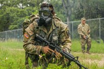 U.S. Army Spc. Justin Earnhart, 470th Military Intelligence Brigade, pulls security while wearing a joint service general purpose mask during an exercise in the Army Futures Command Best Warrior Competition on Fort Sam Houston, Texas, June 9 2021. The Best Warrior Competition evaluates a Soldier’s physical ability, tactical performance and knowledge of Army regulations. (U.S. Army photo by Pfc. Joshua Taeckens) (This photo was edited from its original version)