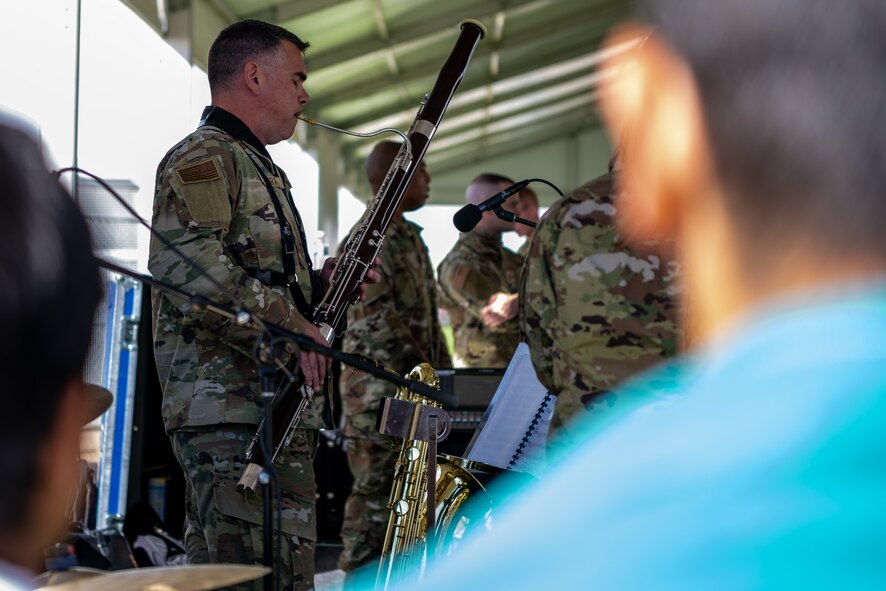 Members of the U.S. Air Force Academy Winds musical ensemble perform for Afghan evacuees at Aman Omid Village on Holloman Air Force Base, New Mexico, Oct. 12, 2021. The Department of Defense, through U.S. Northern Command, and in support of the Department of Homeland Security is providing transportation, temporary housing, medical screening, and general support for at least 50,000 Afghans at suitable facilities, in permanent or temporary structures, as quickly as possible. This initiative provides Afghan personnel essential support at secure locations outside Afghanistan. (U.S. Air Force photo by Senior Airman Skyler Combs)