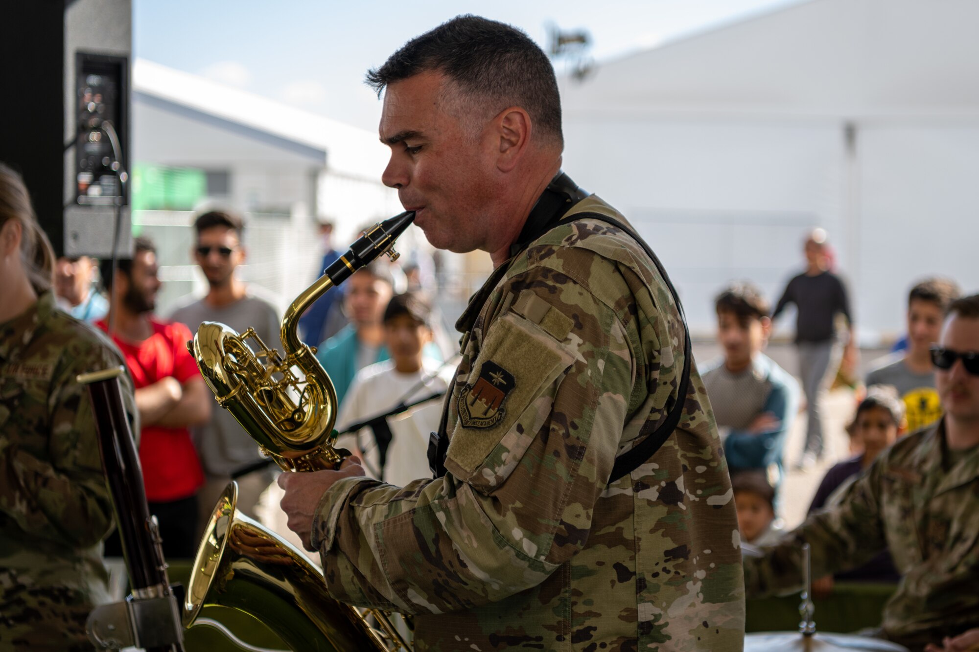 Members of the U.S. Air Force Academy Winds musical ensemble perform for Afghan evacuees at Aman Omid Village on Holloman Air Force Base, New Mexico, Oct. 12, 2021. The Department of Defense, through U.S. Northern Command, and in support of the Department of Homeland Security is providing transportation, temporary housing, medical screening, and general support for at least 50,000 Afghans at suitable facilities, in permanent or temporary structures, as quickly as possible. This initiative provides Afghan personnel essential support at secure locations outside Afghanistan. (U.S. Air Force photo by Senior Airman Skyler Combs)