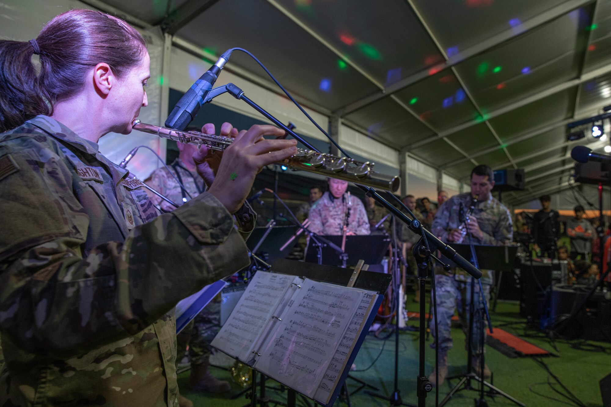 Academy Winds from the U.S. Air Force Academy, performs at Aman Omid Village for Afghan evacuees on Holloman Air Force Base, New Mexico, Oct. 13, 2021. The Department of Defense, through the U.S. Northern Command, and in support of the Department of State and Department of Homeland Security, is providing transportation, temporary housing, medical screening, and general support for at least 50,000 Afghan evacuees at suitable facilities, in permanent or temporary structures, as quickly as possible. This initiative provides Afghan evacuees essential support at secure locations outside Afghanistan. (U.S. Army photo by Spc. Nicholas Goodman)