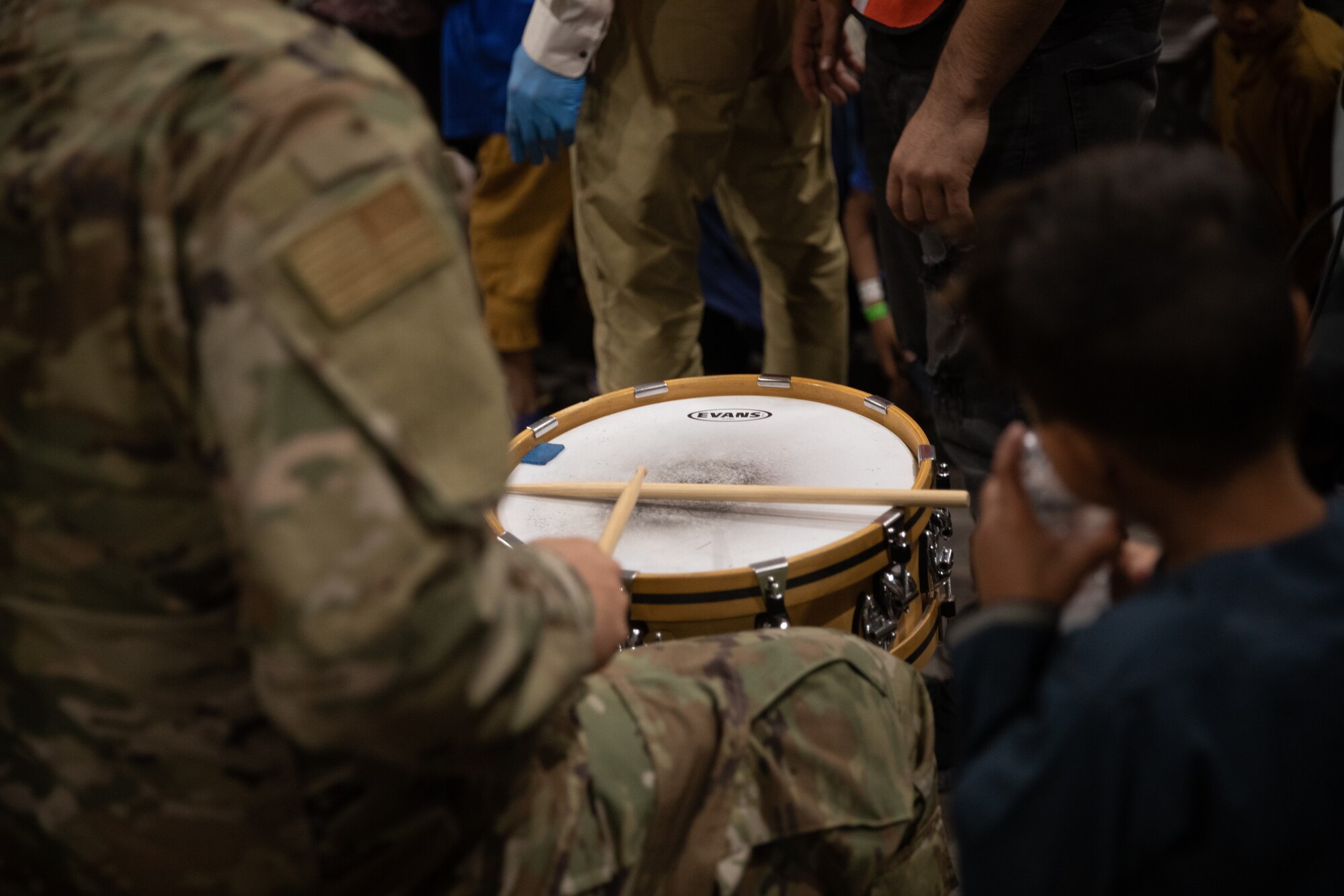 Delta Blue from the U.S. Air Force Academy, performs at Aman Omid Village for Afghan evacuees on Holloman Air Force Base, New Mexico, Oct. 12, 2021. The Department of Defense, through the U.S. Northern Command, and in support of the Department of State and Department of Homeland Security, is providing transportation, temporary housing, medical screening, and general support for at least 50,000 Afghan evacuees at suitable facilities, in permanent or temporary structures, as quickly as possible. This initiative provides Afghan evacuees essential support at secure locations outside Afghanistan. (U.S. Army photo by Spc. Nicholas Goodman)
