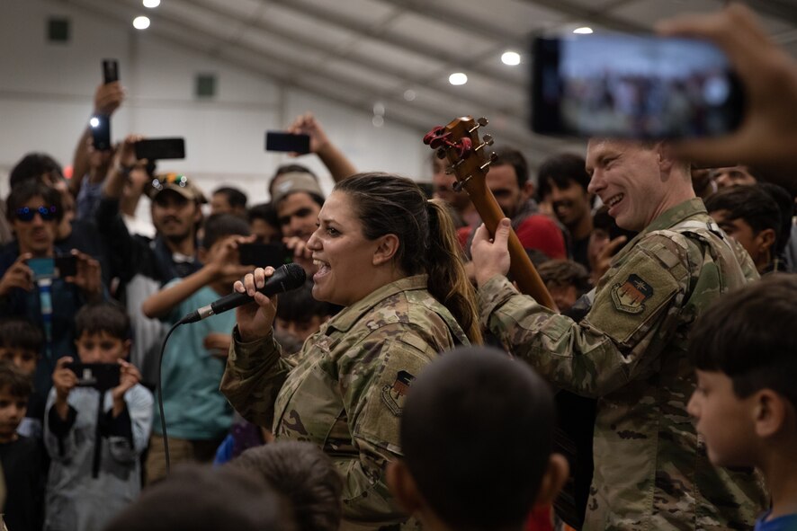 Delta Blue from the U.S. Air Force Academy, performs at Aman Omid Village for Afghan evacuees on Holloman Air Force Base, New Mexico, Oct. 12, 2021. The Department of Defense, through the U.S. Northern Command, and in support of the Department of State and Department of Homeland Security, is providing transportation, temporary housing, medical screening, and general support for at least 50,000 Afghan evacuees at suitable facilities, in permanent or temporary structures, as quickly as possible. This initiative provides Afghan evacuees essential support at secure locations outside Afghanistan. (U.S. Army photo by Spc. Nicholas Goodman)