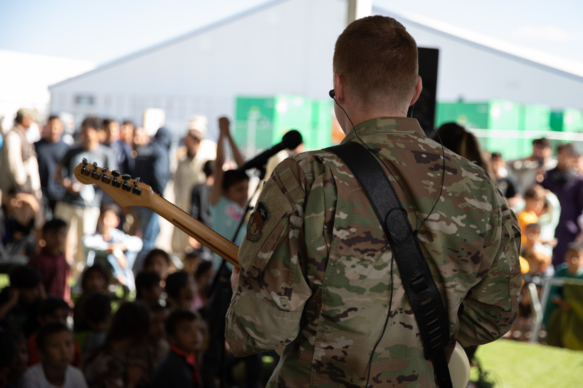 Delta Blue from the U.S. Air Force Academy, performs at Aman Omid Village for Afghan evacuees on Holloman Air Force Base, New Mexico, Oct. 13, 2021. The Department of Defense, through the U.S. Northern Command, and in support of the Department of State and Department of Homeland Security, is providing transportation, temporary housing, medical screening, and general support for at least 50,000 Afghan evacuees at suitable facilities, in permanent or temporary structures, as quickly as possible. This initiative provides Afghan evacuees essential support at secure locations outside Afghanistan. (U.S. Army photo by Spc. Nicholas Goodman)