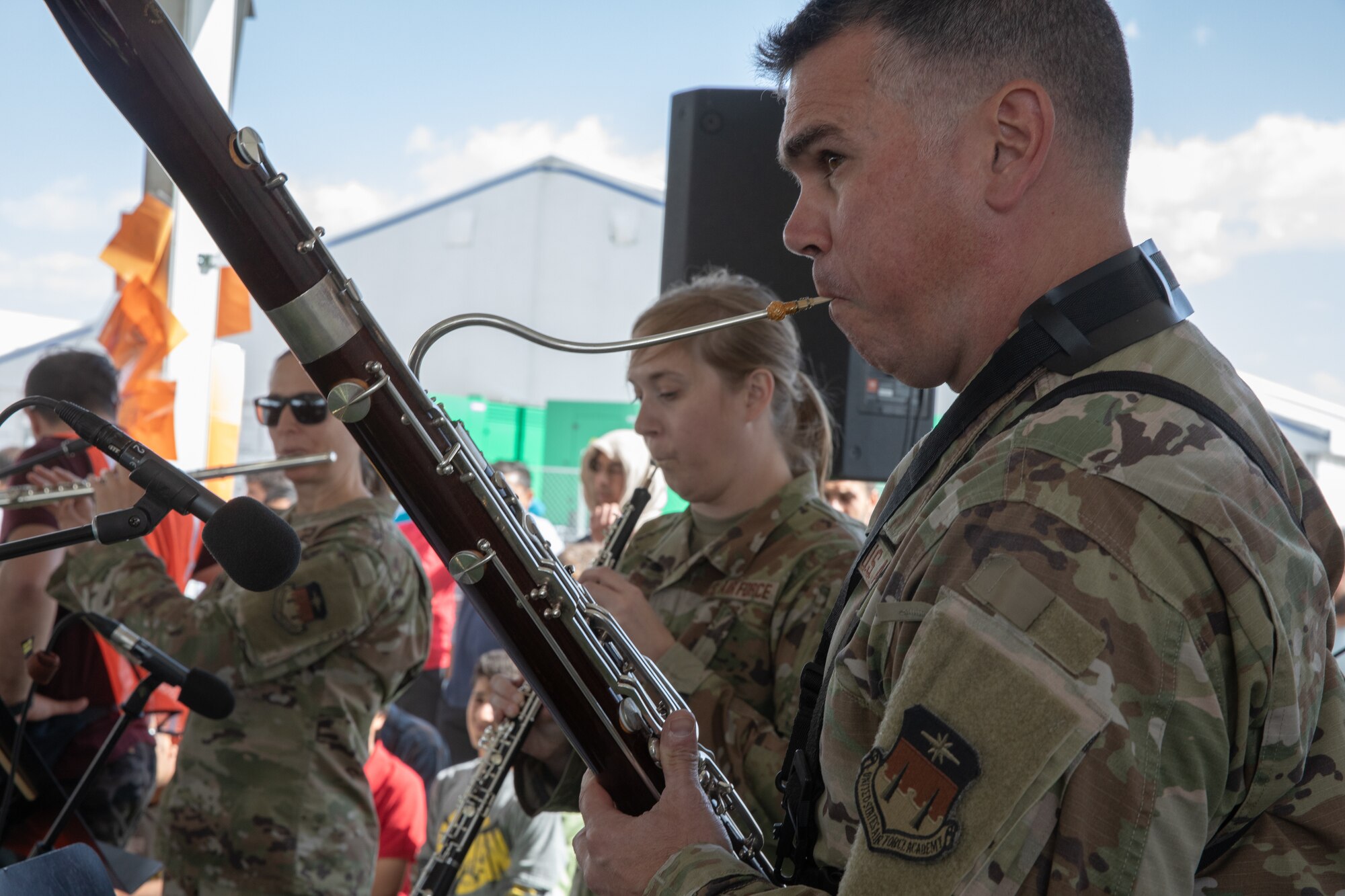 Academy Winds from the U.S. Air Force Academy, performs at Aman Omid Village for Afghan evacuees on Holloman Air Force Base, New Mexico, Oct. 12, 2021. The Department of Defense, through the U.S. Northern Command, and in support of the Department of State and Department of Homeland Security, is providing transportation, temporary housing, medical screening, and general support for at least 50,000 Afghan evacuees at suitable facilities, in permanent or temporary structures, as quickly as possible. This initiative provides Afghan evacuees essential support at secure locations outside Afghanistan. (U.S. Army photo by Spc. Nicholas Goodman)