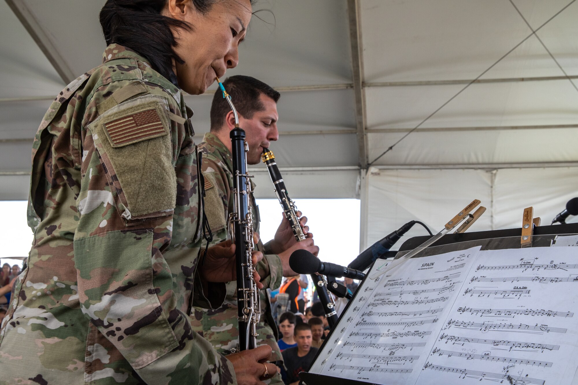 Academy Winds from the U.S. Air Force Academy, performs at Aman Omid Village for Afghan evacuees on Holloman Air Force Base, New Mexico, Oct. 12, 2021. The Department of Defense, through the U.S. Northern Command, and in support of the Department of State and Department of Homeland Security, is providing transportation, temporary housing, medical screening, and general support for at least 50,000 Afghan evacuees at suitable facilities, in permanent or temporary structures, as quickly as possible. This initiative provides Afghan evacuees essential support at secure locations outside Afghanistan. (U.S. Army photo by Spc. Nicholas Goodman)
