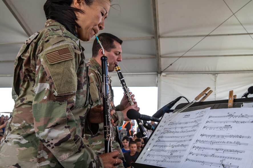 Academy Winds from the U.S. Air Force Academy, performs at Aman Omid Village for Afghan evacuees on Holloman Air Force Base, New Mexico, Oct. 12, 2021. The Department of Defense, through the U.S. Northern Command, and in support of the Department of State and Department of Homeland Security, is providing transportation, temporary housing, medical screening, and general support for at least 50,000 Afghan evacuees at suitable facilities, in permanent or temporary structures, as quickly as possible. This initiative provides Afghan evacuees essential support at secure locations outside Afghanistan. (U.S. Army photo by Spc. Nicholas Goodman)