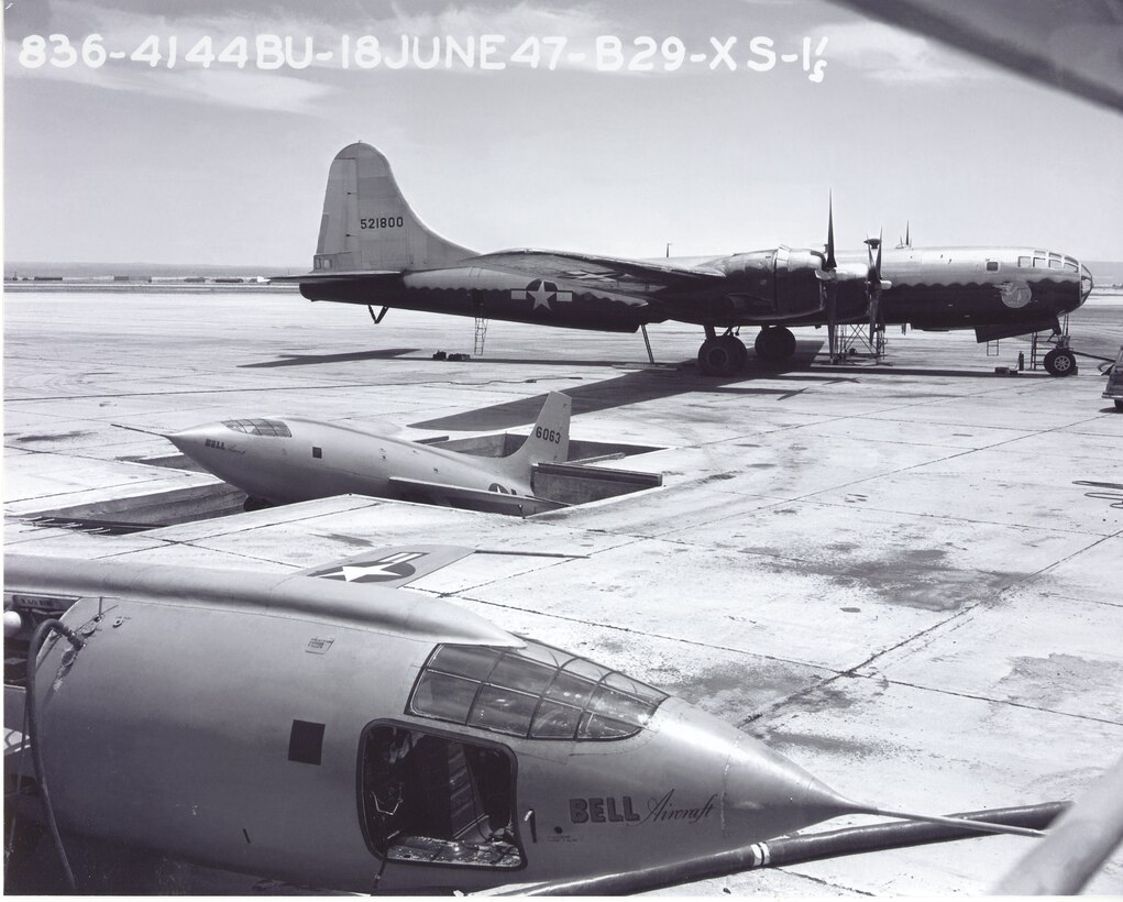 Two Bell X-1s and a modified B-29 on the Edwards Air Force Base, California, flight line. The X-1 was first placed into a pit then attached to the B-29. The X-1 pit is still a prominent landmark on the base. (Photo courtesy of Air Force Test Center History Office)