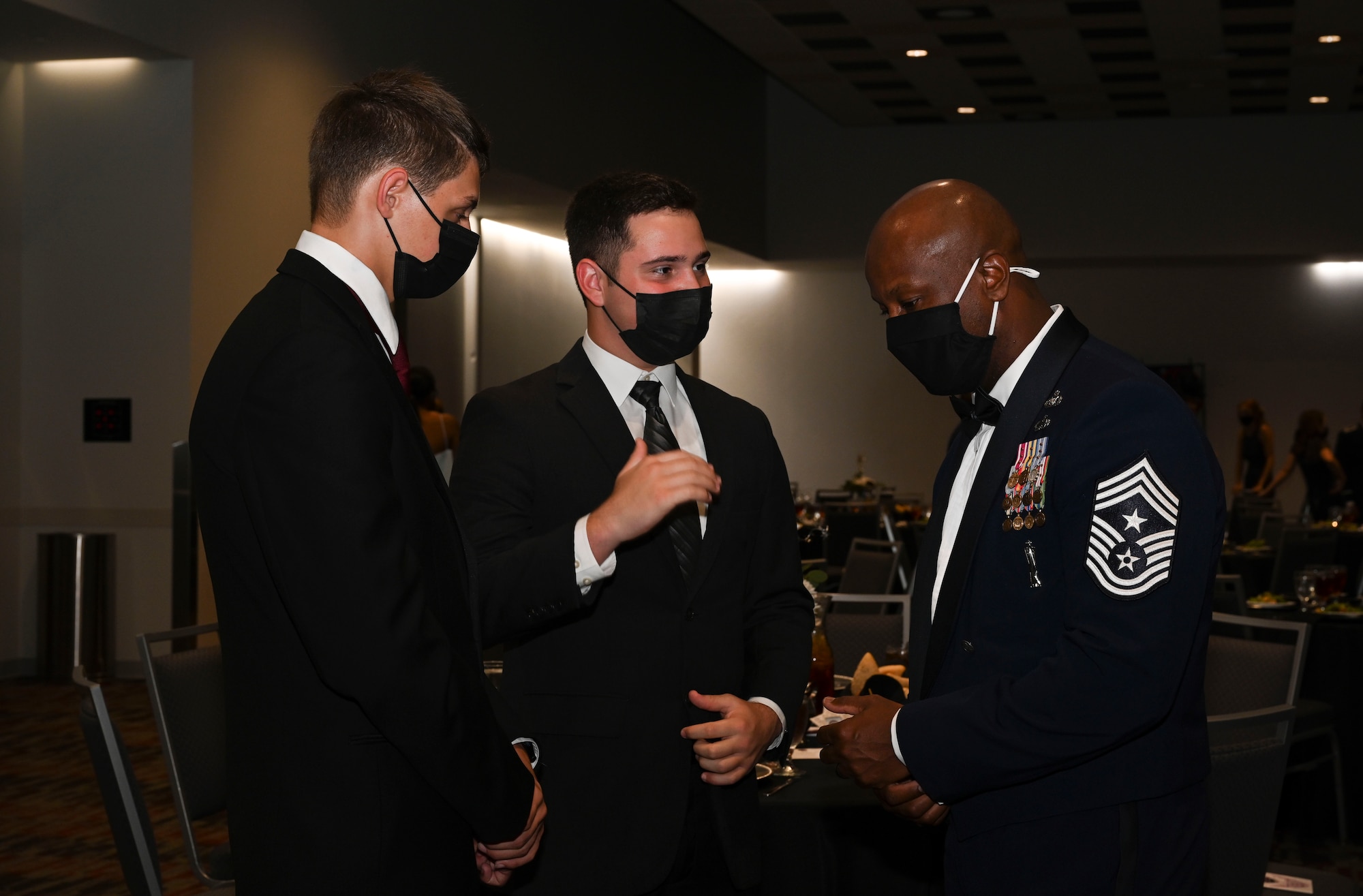 U.S. Air Force Chief Master Sgt. Antonio Cooper, 14th Flying Training Wing command chief, talks with cadets assigned to United States Air Force Detachment 425 assigned to Mississippi State University, during a formal evening event hosted by the detachment, Oct. 13, 2021, at The Mill at Mississippi State University. Due to the global COVID-19 pandemic, this is the first major event hosted by DET 425 since 2019. (U.S Air Force photo by Airman 1st Class Jessica Haynie)