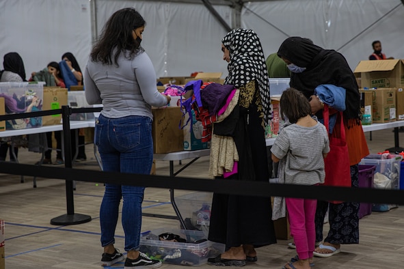 The Department of Homeland Security and Fluor provide Afghan evacuees with donated goods at Task Force-Holloman on Holloman Air Force Base, New Mexico, Oct. 9, 2021. The Department of Defense, through U.S. Northern Command, and in support of the Department of Homeland Security, is providing transportation, temporary housing, medical screening, and general support for at least 50,000 Afghan evacuees at suitable facilities, in permanent or temporary structures, as quickly as possible. This initiative provides Afghan personnel essential support at secure locations outside Afghanistan. (U.S. Army photo by Pfc. Anthony Sanchez)