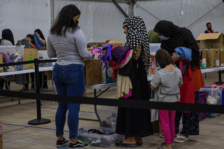 The Department of Homeland Security and Fluor provide Afghan evacuees with donated goods at Task Force-Holloman on Holloman Air Force Base, New Mexico, Oct. 9, 2021. The Department of Defense, through U.S. Northern Command, and in support of the Department of Homeland Security, is providing transportation, temporary housing, medical screening, and general support for at least 50,000 Afghan evacuees at suitable facilities, in permanent or temporary structures, as quickly as possible. This initiative provides Afghan personnel essential support at secure locations outside Afghanistan. (U.S. Army photo by Pfc. Anthony Sanchez)