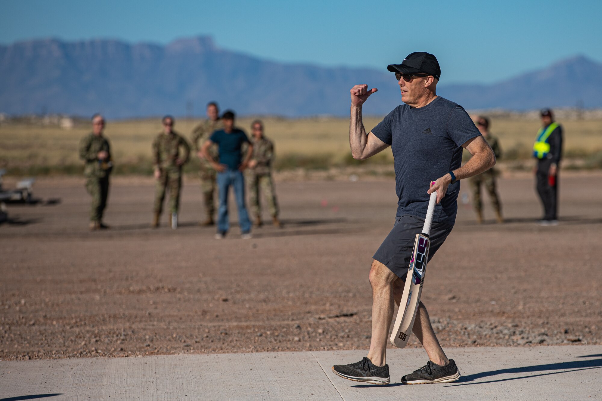 Brig. Gen. Daniel Gabrielli, Task Force-Holloman commander, celebrates during a cricket game between U.S. service members and Afghan evacuees at Aman Omid Village on Holloman Air Force Base, New Mexico, Oct. 9, 2021. The Department of Defense, through U.S. Northern Command, and in support of the Department of Homeland Security, is providing transportation, temporary housing, medical screening, and general support for at least 50,000 Afghan evacuees at suitable facilities, in permanent or temporary structures, as quickly as possible. This initiative provides Afghan personnel essential support at secure locations outside Afghanistan. (U.S. Army photo by Pfc. Anthony Sanchez)