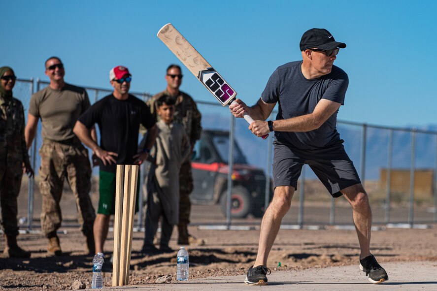Brig. Gen. Daniel Gabrielli, Task Force-Holloman commander, bats during a cricket game between U.S. service members and Afghan evacuees at Aman Omid Village on Holloman Air Force Base, New Mexico, Oct. 9, 2021. The Department of Defense, through U.S. Northern Command, and in support of the Department of Homeland Security, is providing transportation, temporary housing, medical screening, and general support for at least 50,000 Afghan evacuees at suitable facilities, in permanent or temporary structures, as quickly as possible. This initiative provides Afghan personnel essential support at secure locations outside Afghanistan. (U.S. Army photo by Pfc. Anthony Sanchez)
