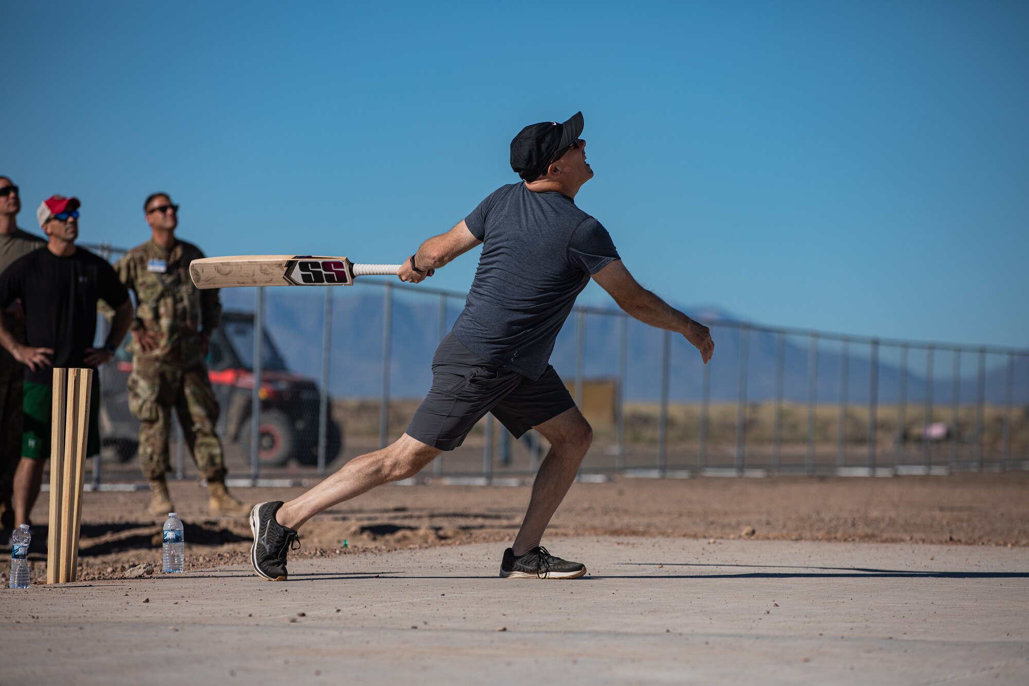 Brig. Gen. Daniel Gabrielli, Task Force Holloman commander, runs after batting the ball during a cricket game between U.S. service members and Afghan evacuees at Aman Omid Village on Holloman Air Force Base, New Mexico, Oct. 9, 2021. The Department of Defense, through U.S. Northern Command, and in support of the Department of Homeland Security, is providing transportation, temporary housing, medical screening, and general support for at least 50,000 Afghan evacuees at suitable facilities, in permanent or temporary structures, as quickly as possible. This initiative provides Afghan personnel essential support at secure locations outside Afghanistan. (U.S. Army photo by Pfc. Anthony Sanchez)