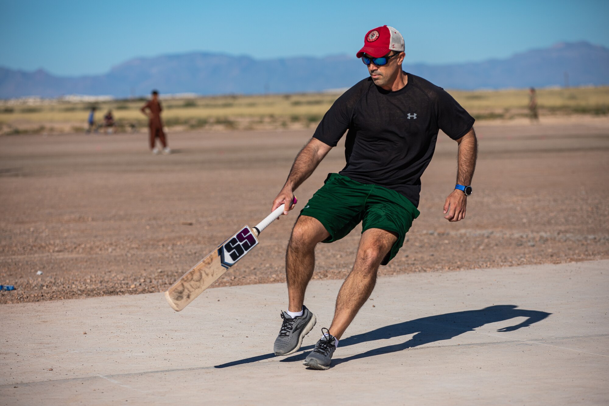 Lt. Col. Taylor Francis, Task Force-Holloman director of operations deployed from Seymour Johnson Air Force Base, North Carolina, rounds the cricket field during a cricket game between U.S. service members and Afghan evacuees at Aman Omid Village on Holloman Air Force Base, New Mexico, Oct. 9, 2021. The Department of Defense, through U.S. Northern Command, and in support of the Department of Homeland Security, is providing transportation, temporary housing, medical screening, and general support for at least 50,000 Afghan evacuees at suitable facilities, in permanent or temporary structures, as quickly as possible. This initiative provides Afghan personnel essential support at secure locations outside Afghanistan. (U.S. Army photo by Pfc. Anthony Sanchez)