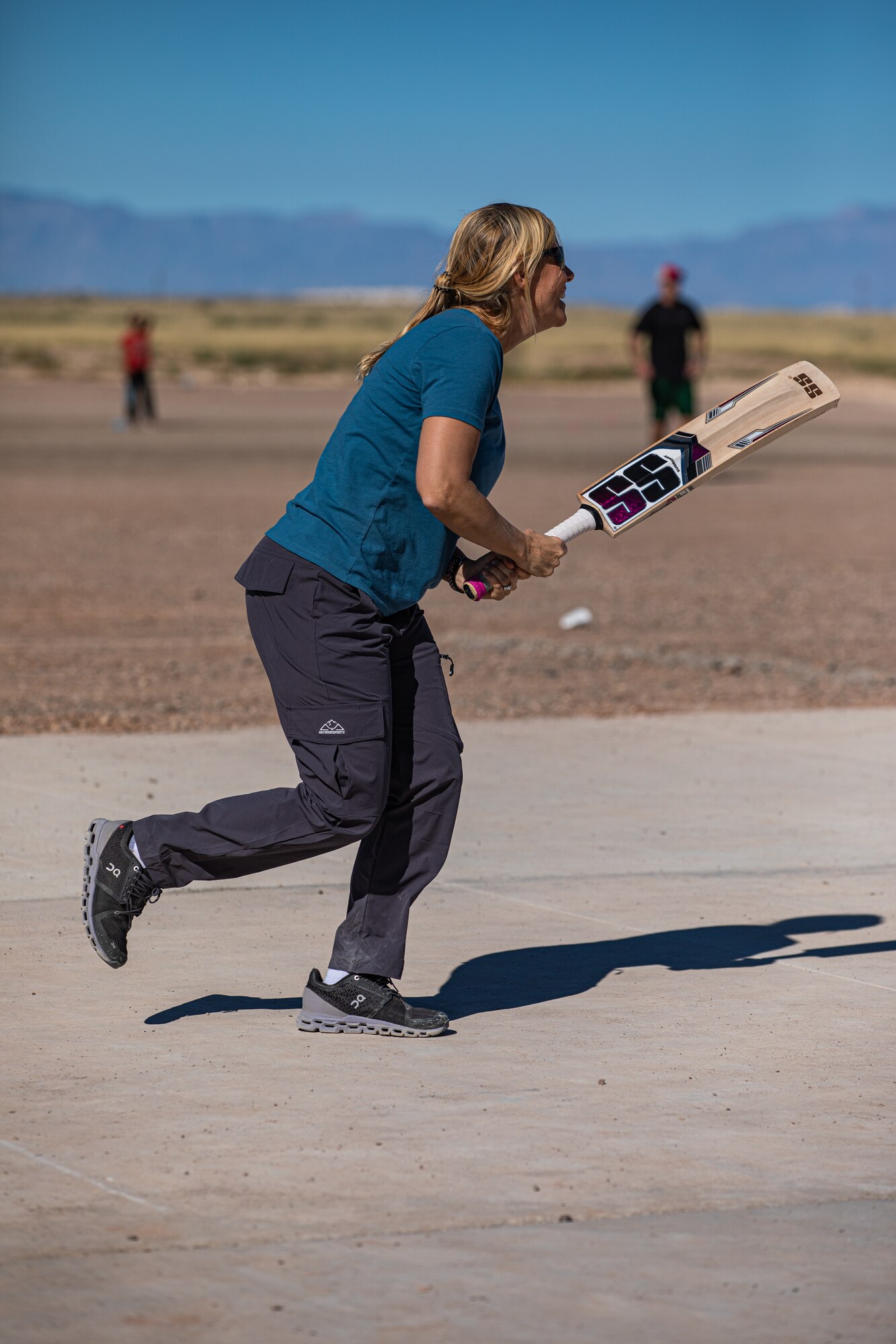 Col. Meredith Seeley, Task Force-Holloman deputy commander deployed from MacDill Air Force Base, Florida, plays during a cricket game between U.S. service members and Afghan evacuees at Aman Omid Village on Holloman Air Force Base, New Mexico, Oct. 9, 2021. The Department of Defense, through U.S. Northern Command, and in support of the Department of Homeland Security, is providing transportation, temporary housing, medical screening, and general support for at least 50,000 Afghan evacuees at suitable facilities, in permanent or temporary structures, as quickly as possible. This initiative provides Afghan personnel essential support at secure locations outside Afghanistan. (U.S. Army photo by Pfc. Anthony Sanchez)