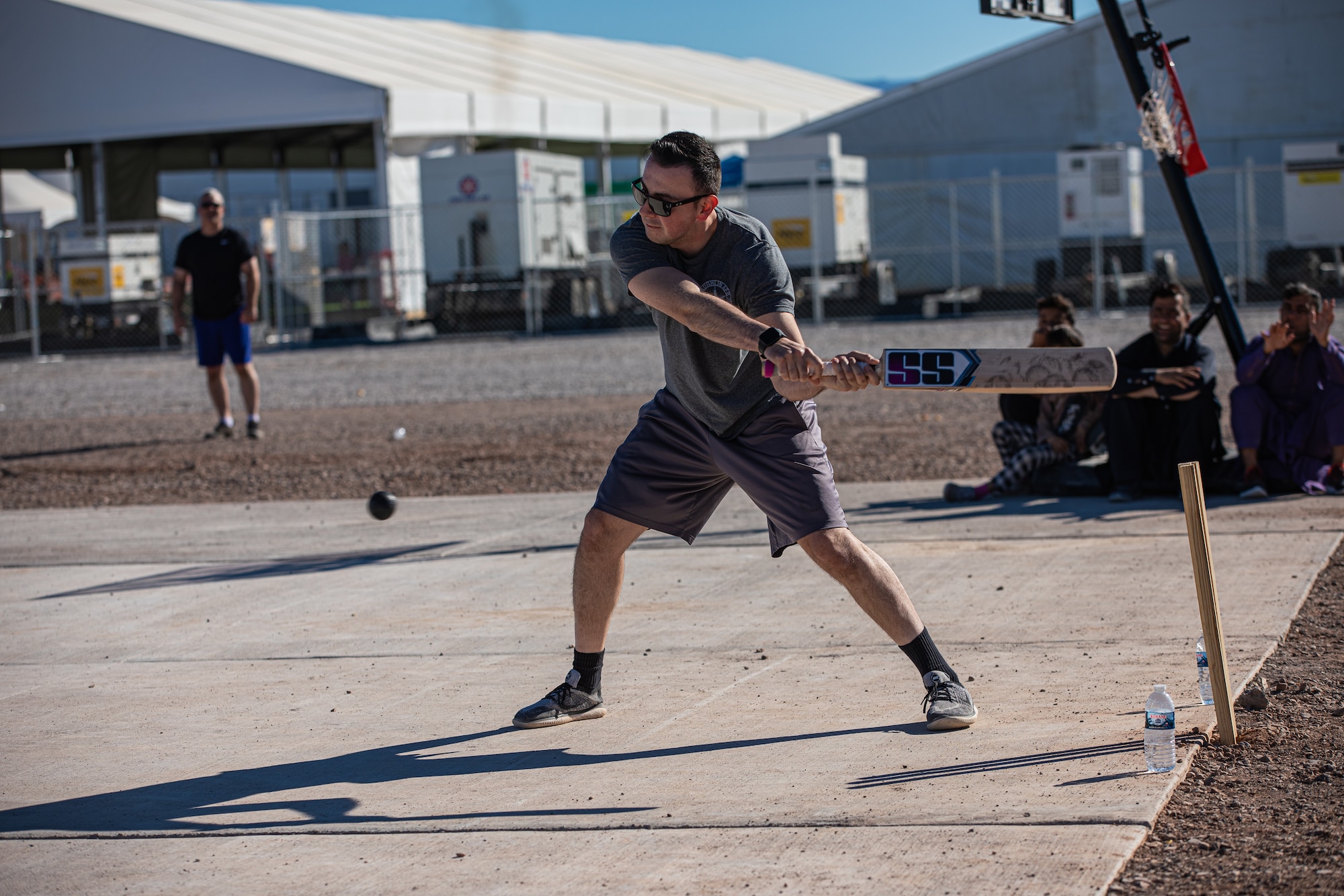 Capt. Daniel Rubio, Task Force-Holloman public affairs officer deployed from Laughlin Air Force Base, Texas, bats during a cricket game between U.S. service members and Afghan evacuees at Aman Omid Village on Holloman Air Force Base, New Mexico, Oct. 9, 2021. The Department of Defense, through U.S. Northern Command, and in support of the Department of Homeland Security, is providing transportation, temporary housing, medical screening, and general support for at least 50,000 Afghan evacuees at suitable facilities, in permanent or temporary structures, as quickly as possible. This initiative provides Afghan personnel essential support at secure locations outside Afghanistan. (U.S. Army photo by Pfc. Anthony Sanchez)