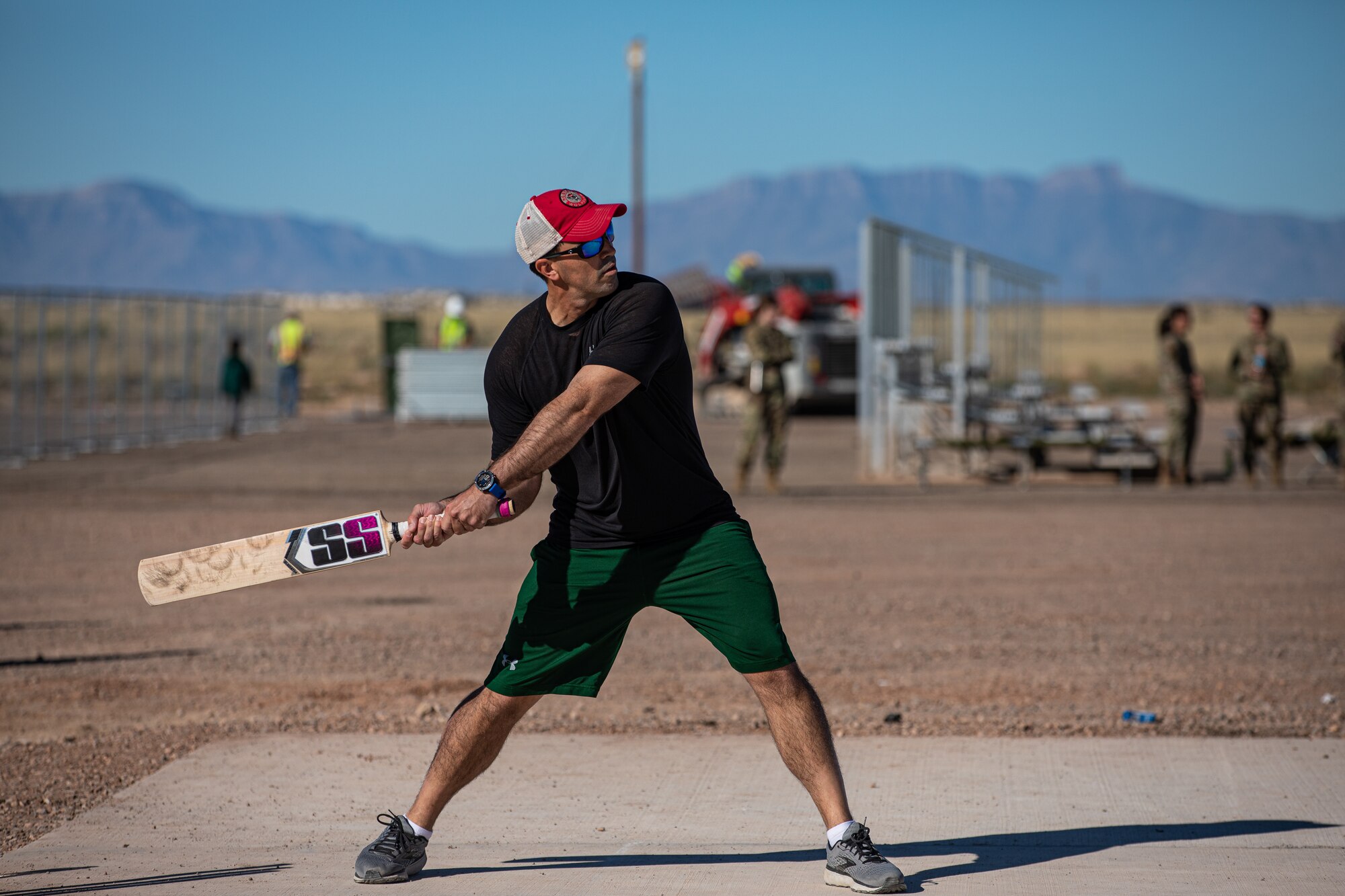 Lt. Col. Taylor Francis, Task Force-Holloman director of operations deployed from Seymour Johnson Air Force Base, North Carolina, bats during a cricket game between U.S. service members and Afghan evacuees at Aman Omid Village on Holloman Air Force Base, New Mexico, Oct. 9, 2021. The Department of Defense, through U.S. Northern Command, and in support of the Department of Homeland Security, is providing transportation, temporary housing, medical screening, and general support for at least 50,000 Afghan evacuees at suitable facilities, in permanent or temporary structures, as quickly as possible. This initiative provides Afghan personnel essential support at secure locations outside Afghanistan. (U.S. Army photo by Pfc. Anthony Sanchez)