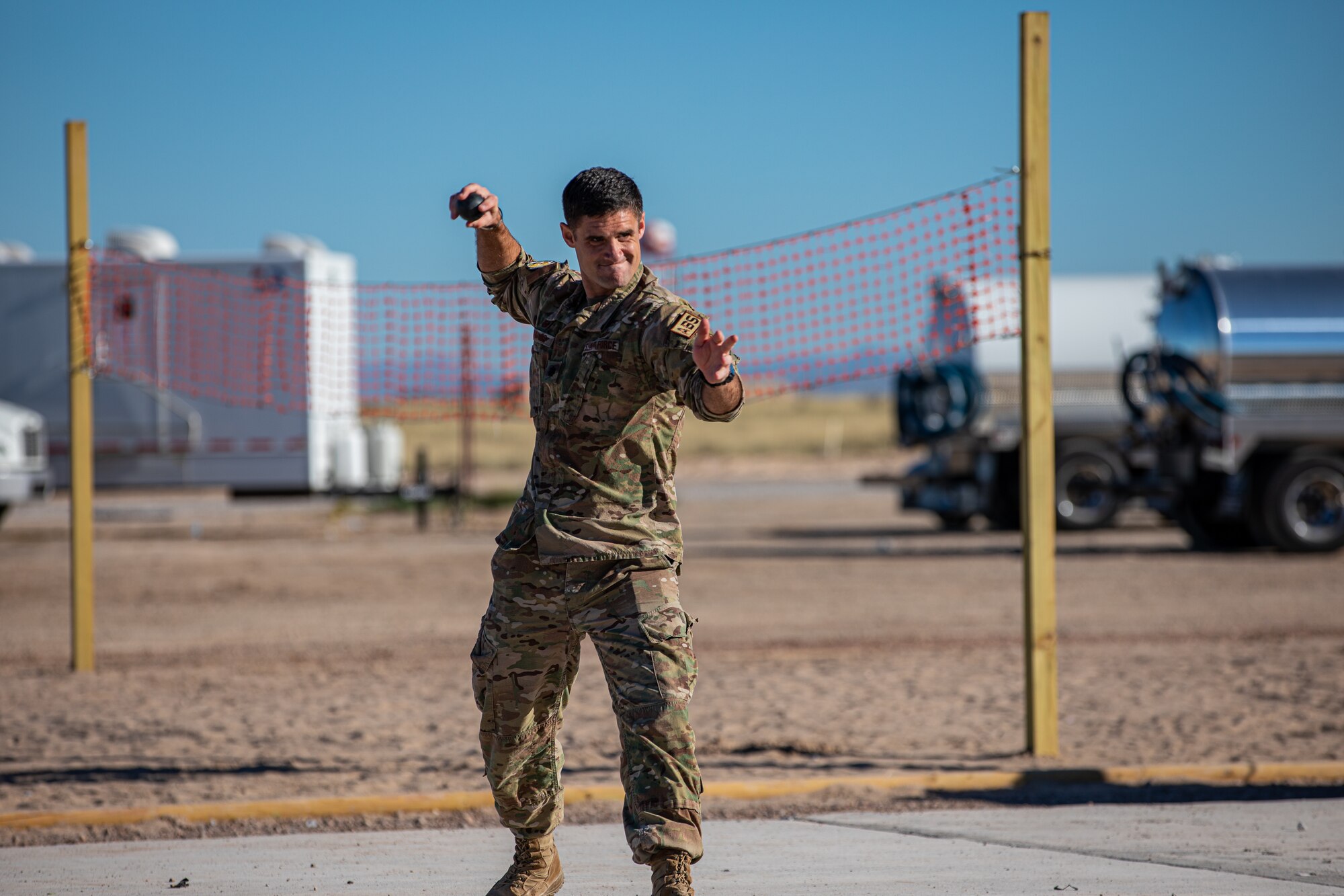 Lt. Col. Michael Hawkins, Task Force-Holloman contracting officer deployed from Seymour Johnson Air Force Base, North Carolina, throws a ball during a cricket game between U.S. service members and Afghan evacuees at Aman Omid Village on Holloman Air Force Base, New Mexico, Oct. 9, 2021. The Department of Defense, through U.S. Northern Command, and in support of the Department of Homeland Security, is providing transportation, temporary housing, medical screening, and general support for at least 50,000 Afghan evacuees at suitable facilities, in permanent or temporary structures, as quickly as possible. This initiative provides Afghan personnel essential support at secure locations outside Afghanistan. (U.S. Army photo by Pfc. Anthony Sanchez)