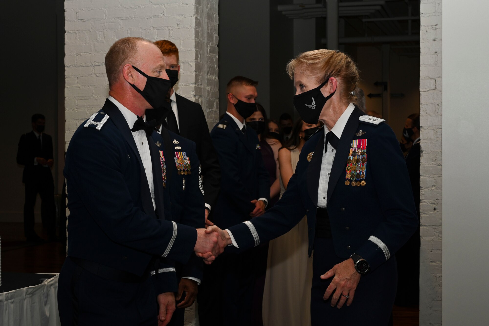 U.S. Air Force Maj. Gen. Jeannie Leavitt, Department of the Air Force chief of safety, Headquaters U.S. Air Force Arlington, VA., and Air Force Safety Center commander, Kirtland Air Force Base, NM., greets Col. Seth Graham, 14th Flying Training Wing commander, during a formal evening event hosted by the Mississippi State University, United States Air Force Detachment 425, , Starkville, Miss. Oct. 13, 2021. Leavitt was commander of the 4th Fighter Wing, Seymour Johnson AFB, N.C., in 2012, making her the first woman to command a United States Air Force combat fighter wing. (U.S Air Force photo by Airman 1st Class Jessica Haynie)