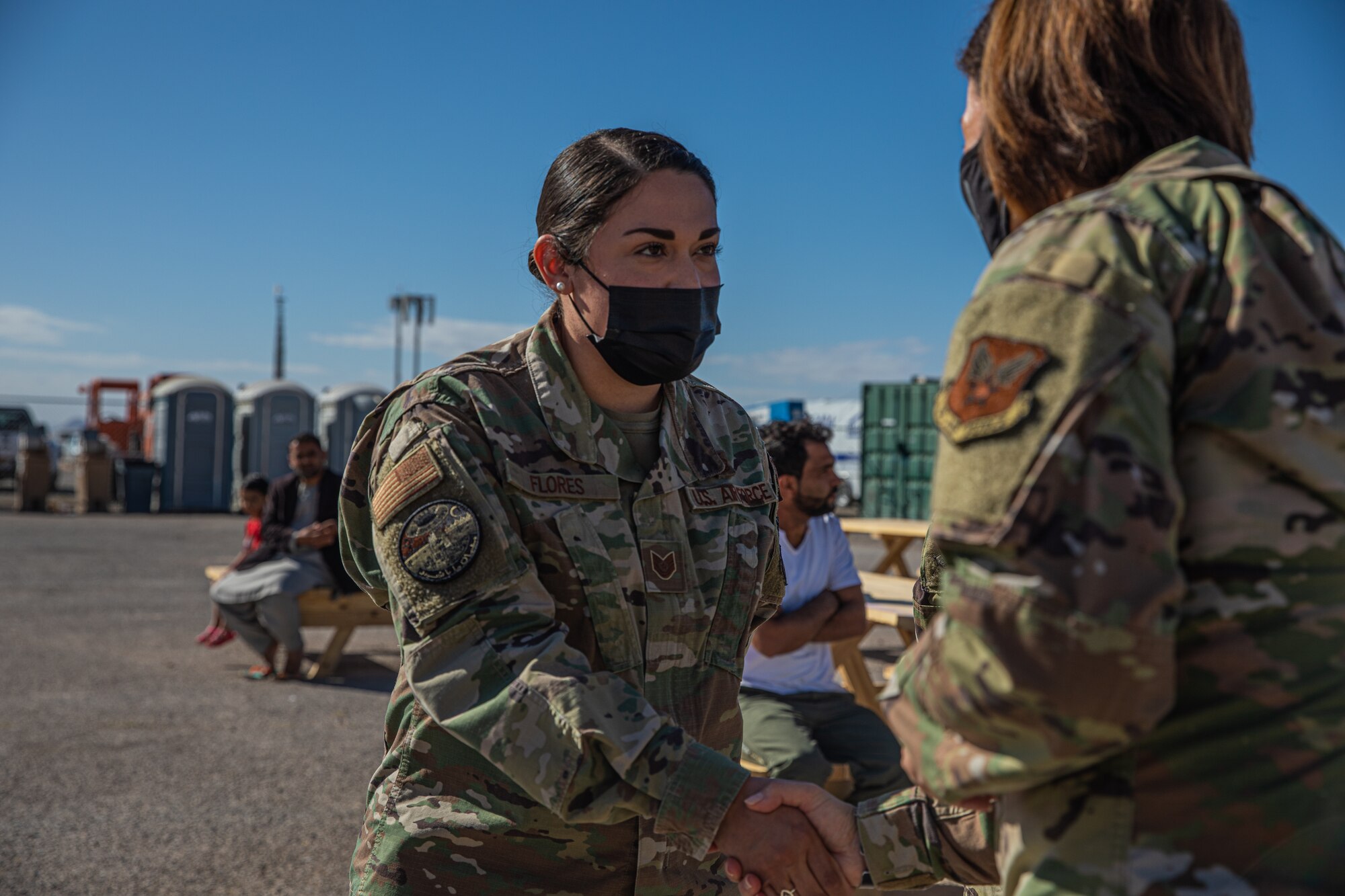 Chief Master Sgt. of the Air Force JoAnne S. Bass presents a coin to Tech. Sgt. April Flores, Task Force-Holloman noncommissioned officer in charge of immunizations deployed from Sheppard Air Force Base, Texas, on Holloman AFB, New Mexico, Oct. 13, 2021. The Department of Defense, through U.S. Northern Command, and in support of the Department of Homeland Security, is providing transportation, temporary housing, medical screening, and general support for at least 50,000 Afghan evacuees at suitable facilities, in permanent or temporary structures, as quickly as possible. This initiative provides Afghan personnel essential support at secure locations outside Afghanistan. (U.S. Army photo by Pfc. Anthony Sanchez)