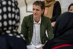 Erin Cooper, a woman, peace and policy analyst with the Secretary of Defense and deployed to Task Force-Holloman as a gender advisor, sits in on a women’s meeting at Aman Omid Village on Holloman Air Force Base, New Mexico, Oct. 7, 2021. The Department of Defense, through U.S. Northern Command, and in support of the Department of Homeland Security is providing transportation, temporary housing, medical screening, and general support for at least 50,000 Afghans at suitable facilities, in permanent or temporary structures, as quickly as possible. This initiative provides Afghan personnel essential support at secure locations outside Afghanistan. (U.S. Air Force photo by Senior Airman Skyler Combs)