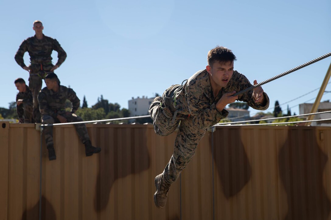 U.S Marine Corps Cpl. Devin Sims, a native of Athens, Ala., and a team leader with 1st Battalion, 6th Marine Regiment, 2d Marine Division, participates in an obstacle course during Exercise Baccarat on Caserne Colonel de Chabrières Nîmes, France, Oct. 8, 2021. Exercise Baccarat is a three-week joint exercise between 2d MARDIV and the French Foreign Legion that challenges forces with physical and tactical training, as well as provides the opportunity to exchange knowledge that assists in developing and strengthening bonds. (U.S. Marine Corps photo by Lance Cpl. Jennifer E. Reyes)