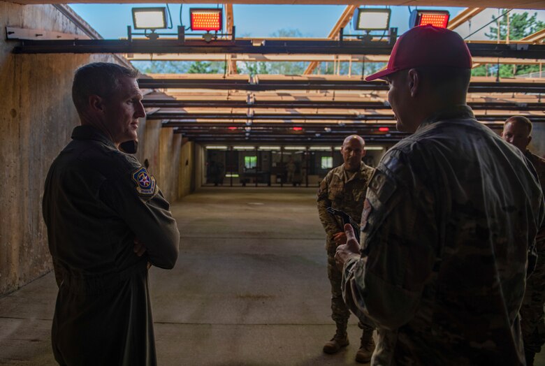 Brig. Gen. Jason Rueschhoff, 7th Air Force deputy commander, receives a briefing from Staff Sgt. Giancarlo Wolfe, 8th Security Forces Squadron combat arms instructor, about the indoor shooting range by at Kunsan Air Base, Republic of Korea, Oct. 14, 2021. Rueschhoff also visited the O’Malley Dining Facility, enlisted dorms, flightline and received a Rapid Airfield Damage Assessment demonstration. (U.S. Air Force photo by Senior Airman Suzie Plotnikov)