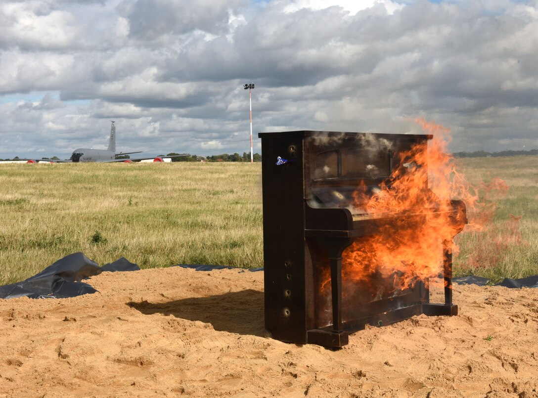 A piano burns after being set alight as part of a Royal Air Force tradition both to honor the memory of the 13 U.S. service members who lost their lives in the Kabul airport bombing in Afghanistan in August, and to celebrate the end of a successful flying and fiscal year at Royal Air Force Mildenhall, England, Oct. 1, 2021. Claims behind the tradition include stories that it reportedly started during World War II to honor fallen pilots. (U.S. Air Force photo by Karen Abeyasekere)