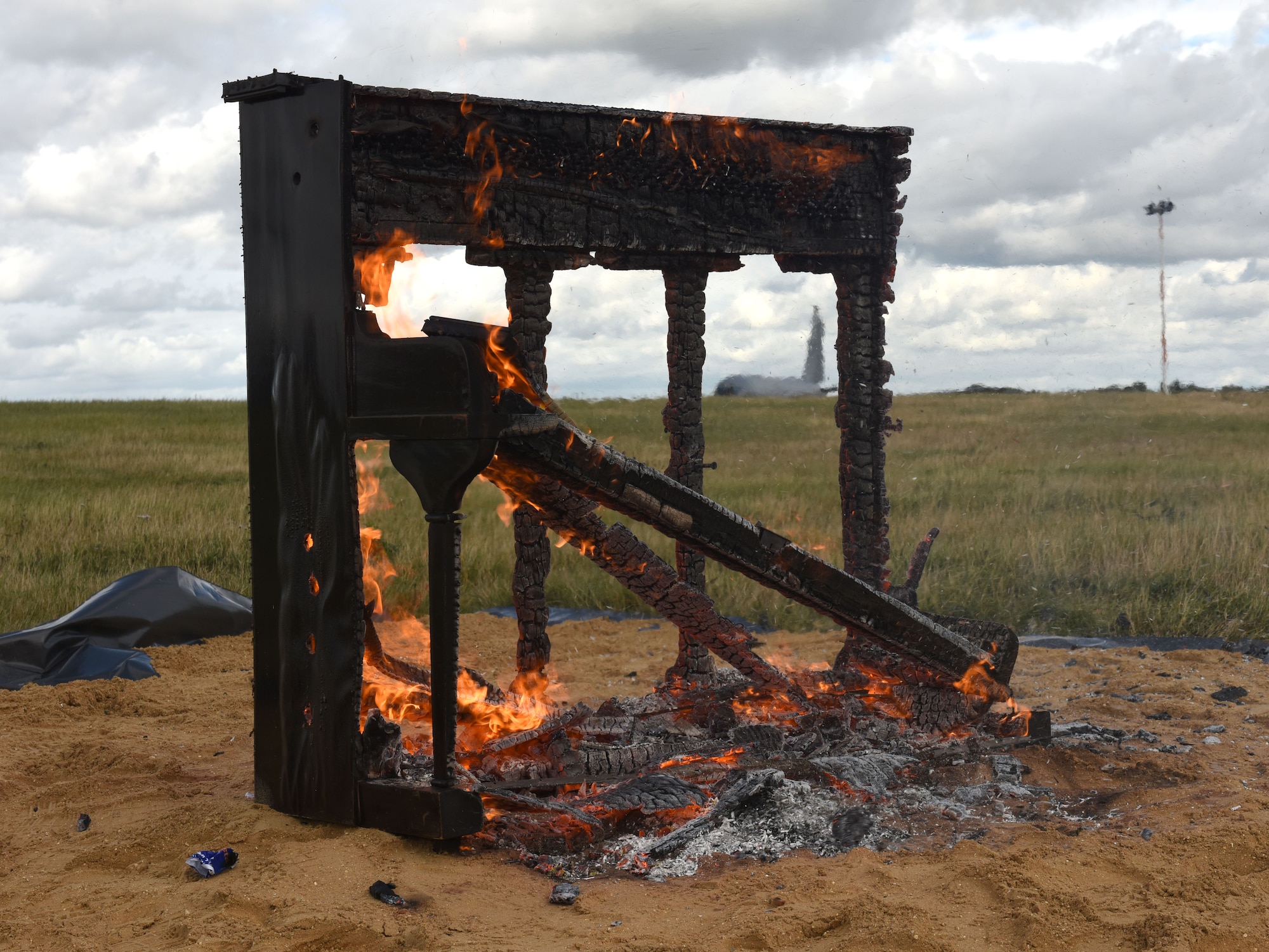 A piano smolders after being set on fire during a piano burn at Royal Air Force Mildenhall, England, Oct. 1, 2021. Claims behind the tradition include stories that it reportedly started during World War II to honor fallen pilots, allegedly one being a skilled piano player. After every battle he would provide merriment and joy, but was when he was killed in battle, the tunes stopped. The rest of his squadron
flying and fiscal year for 2021, and the team’s hard work in getting the mission done. (U.S. Air Force photo by Karen Abeyasekere)