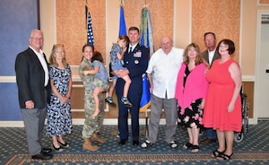 Group of people posing for family photo.